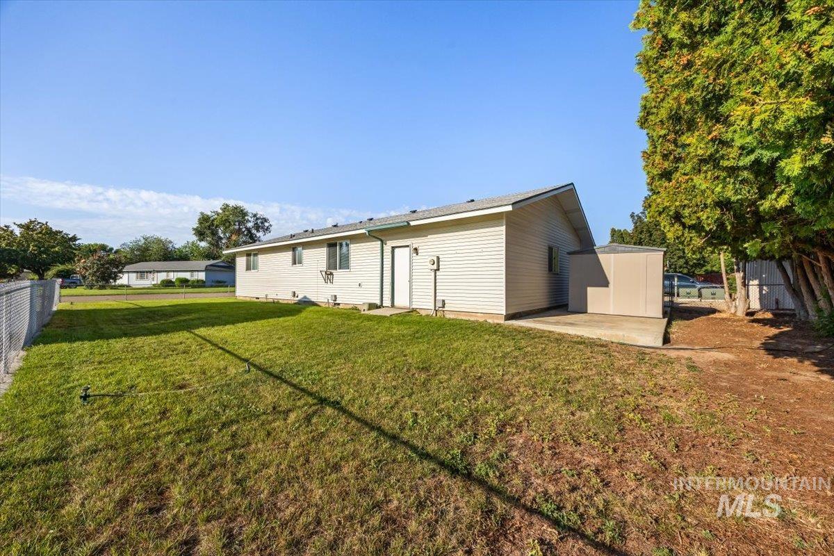 Back of house featuring a patio area and an outdoor structure