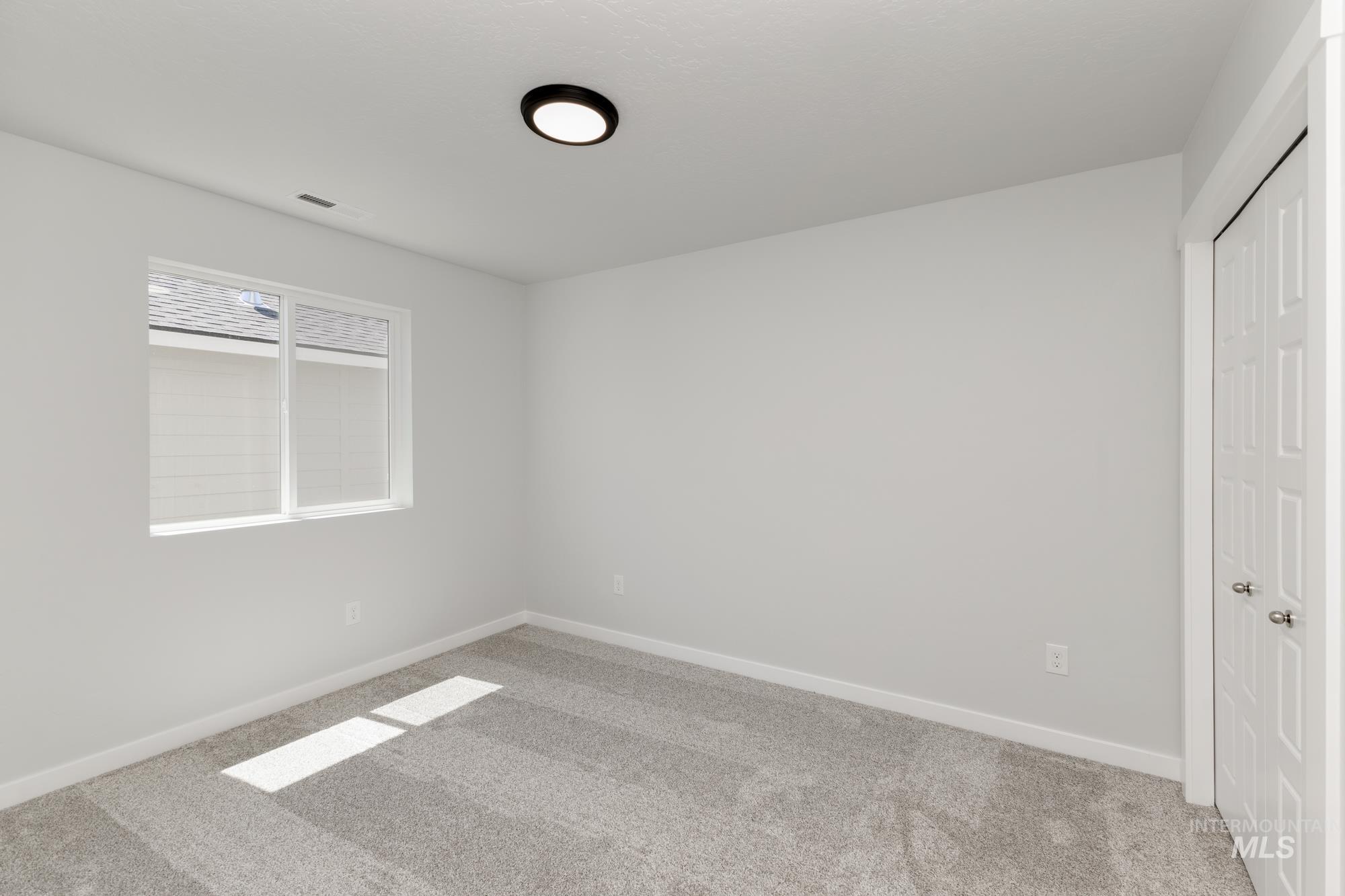 Unfurnished bedroom featuring carpet flooring and a closet