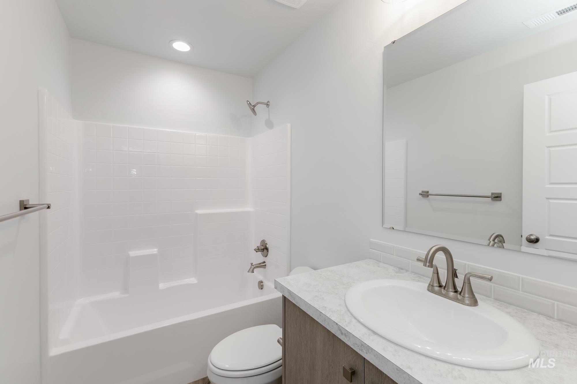 Bathroom with vanity and tub / shower combination