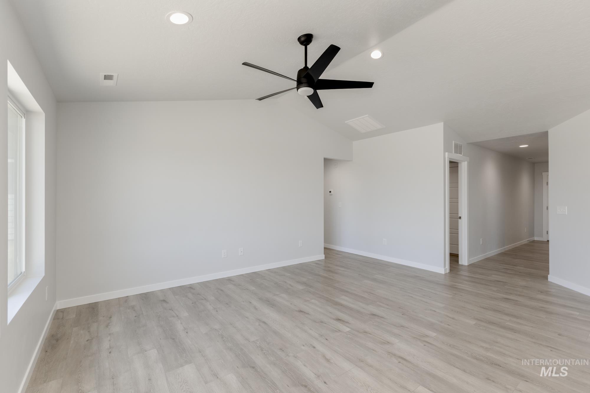 Spare room featuring recessed lighting, light wood-style floors, vaulted ceiling, and ceiling fan