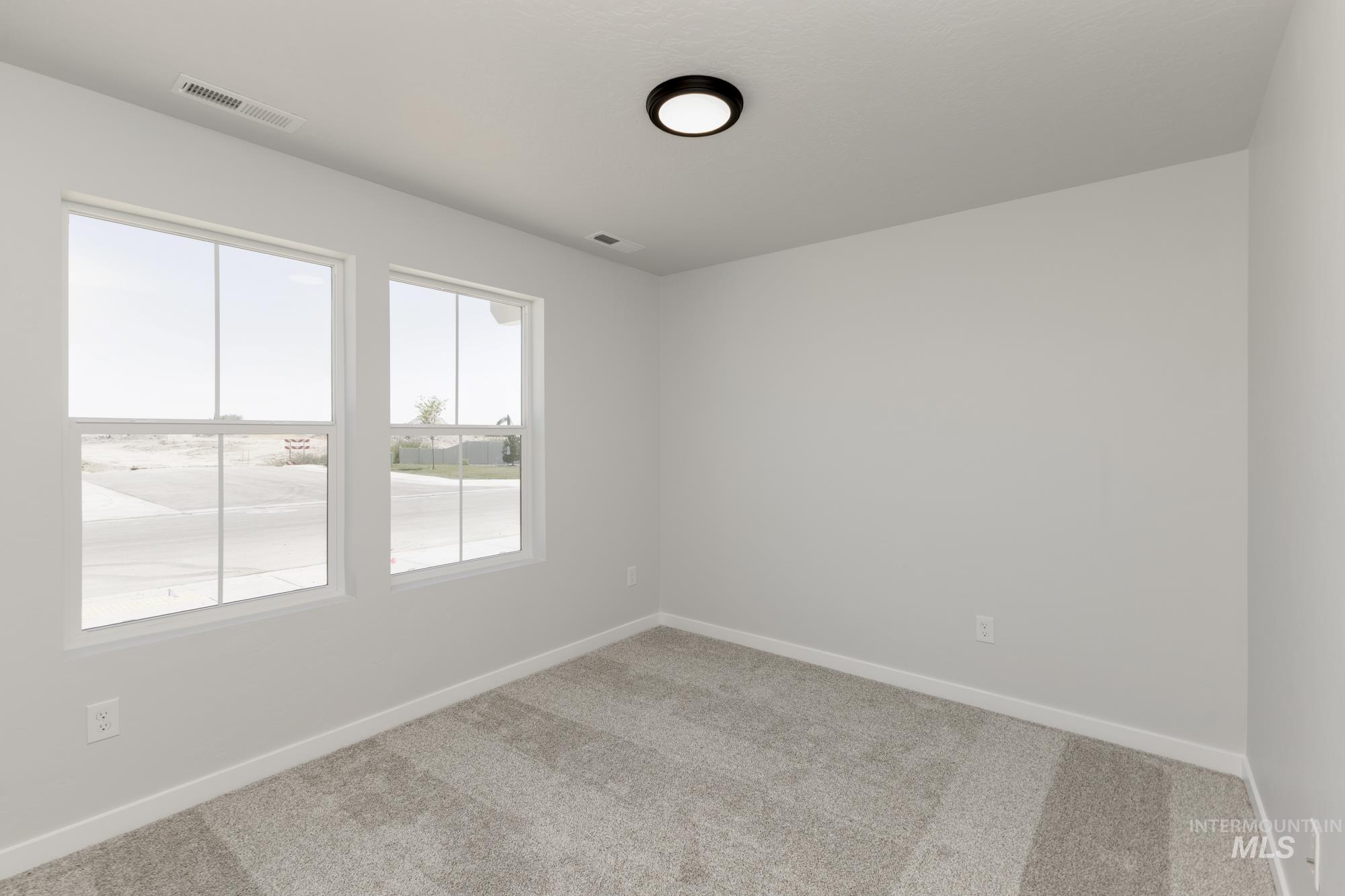 Unfurnished room featuring carpet and baseboards