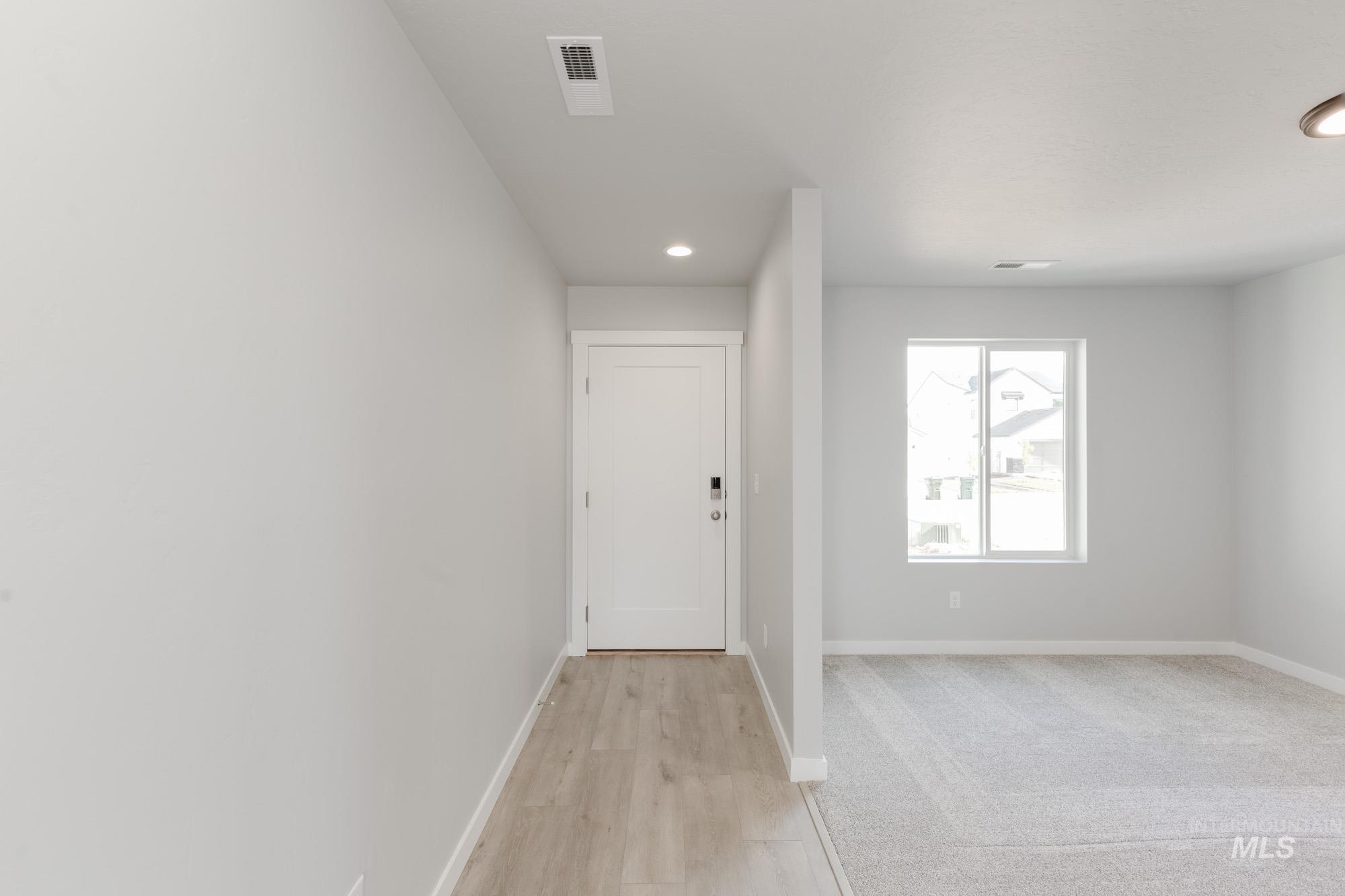 Corridor featuring recessed lighting and light wood-style flooring