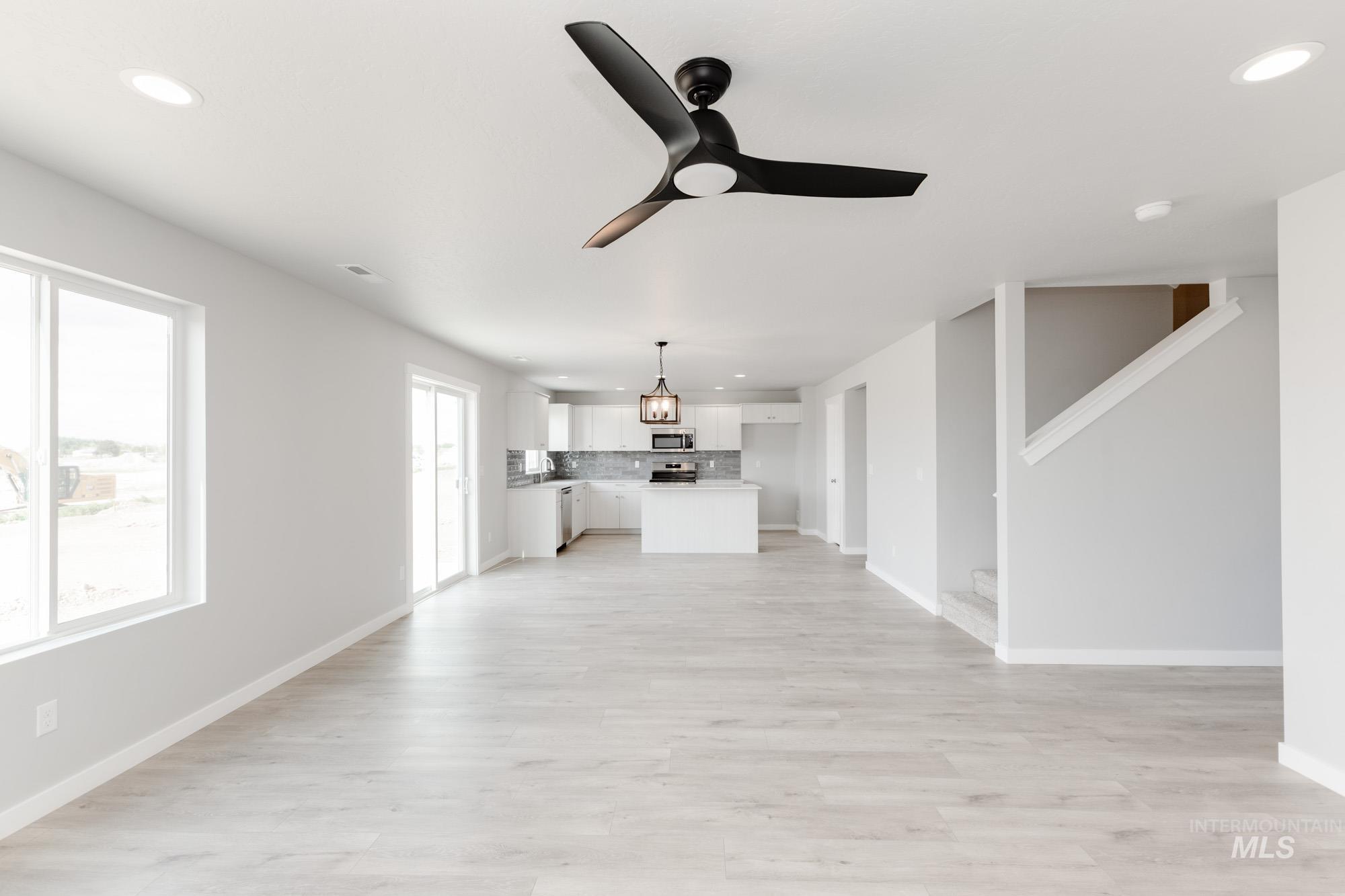 Unfurnished living room with recessed lighting, a ceiling fan, and light wood finished floors