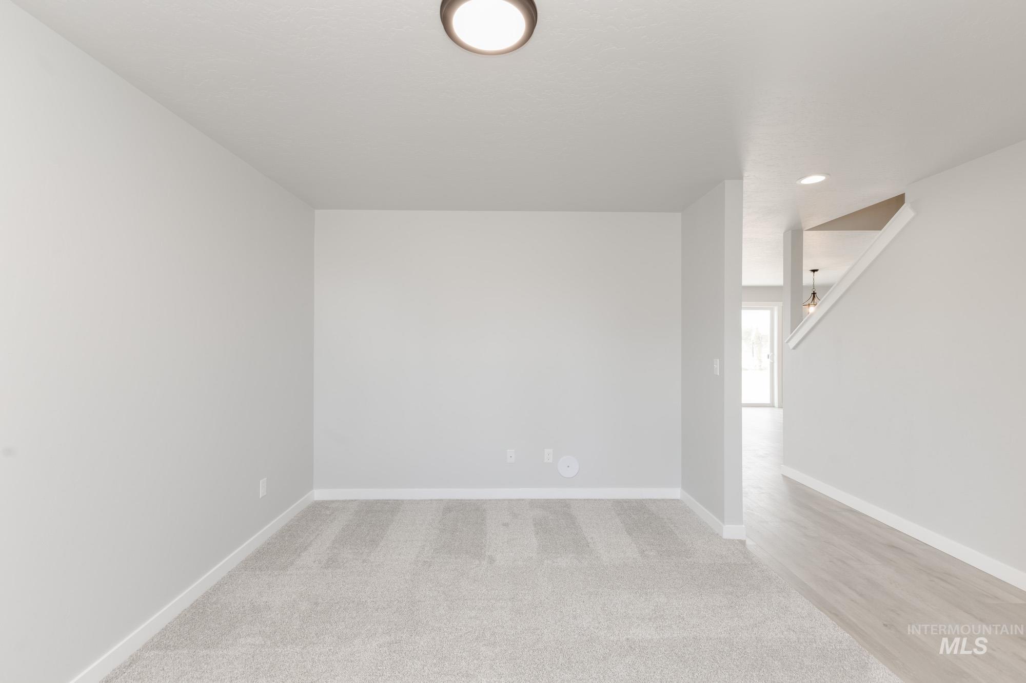 Spare room featuring light colored carpet and recessed lighting