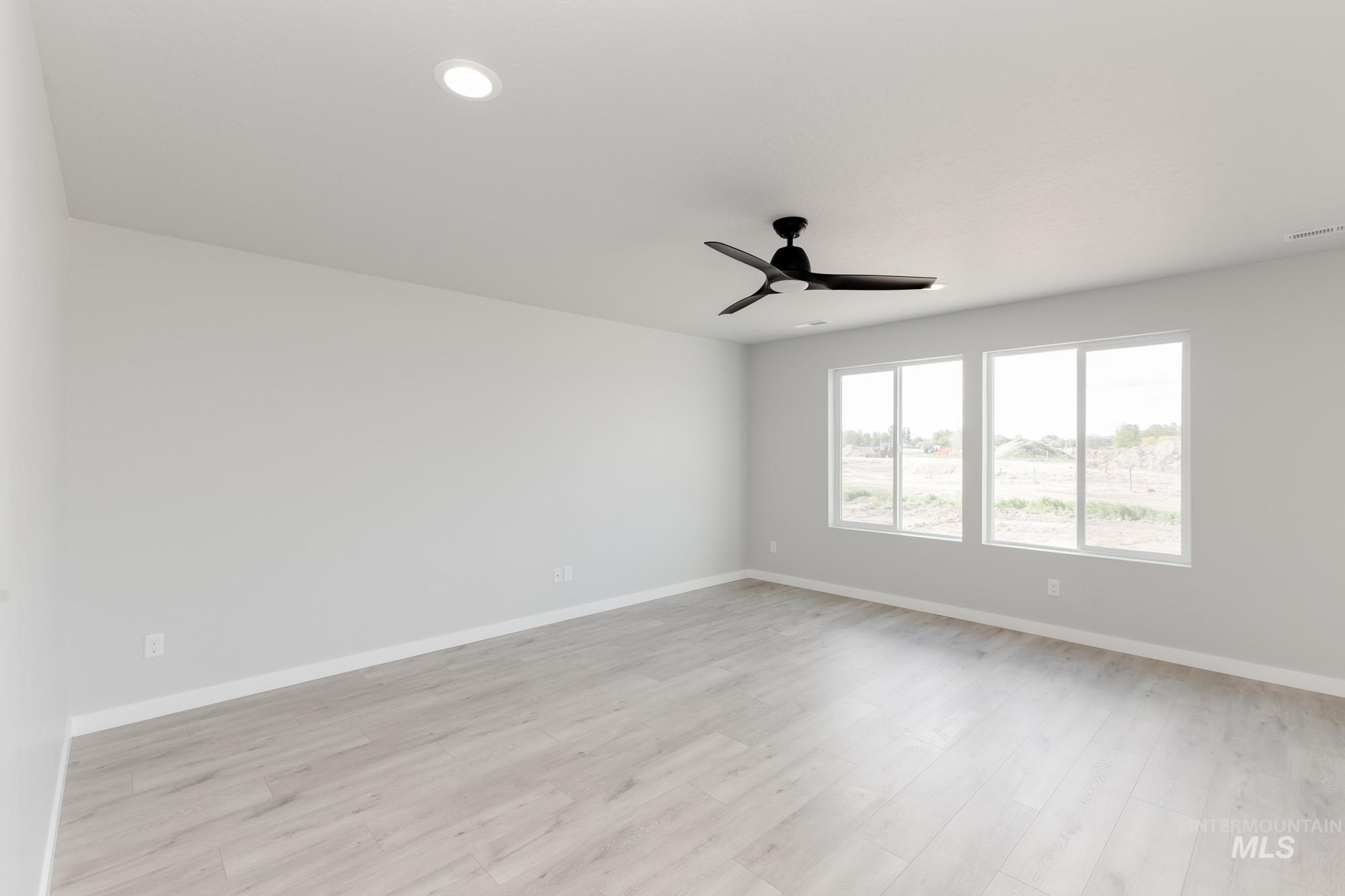 Unfurnished room with ceiling fan, light wood-style floors, and recessed lighting