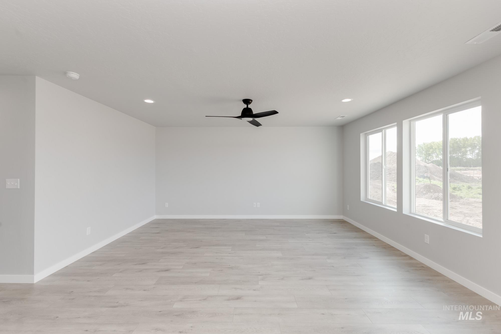 Spare room with light wood-style flooring, ceiling fan, and recessed lighting