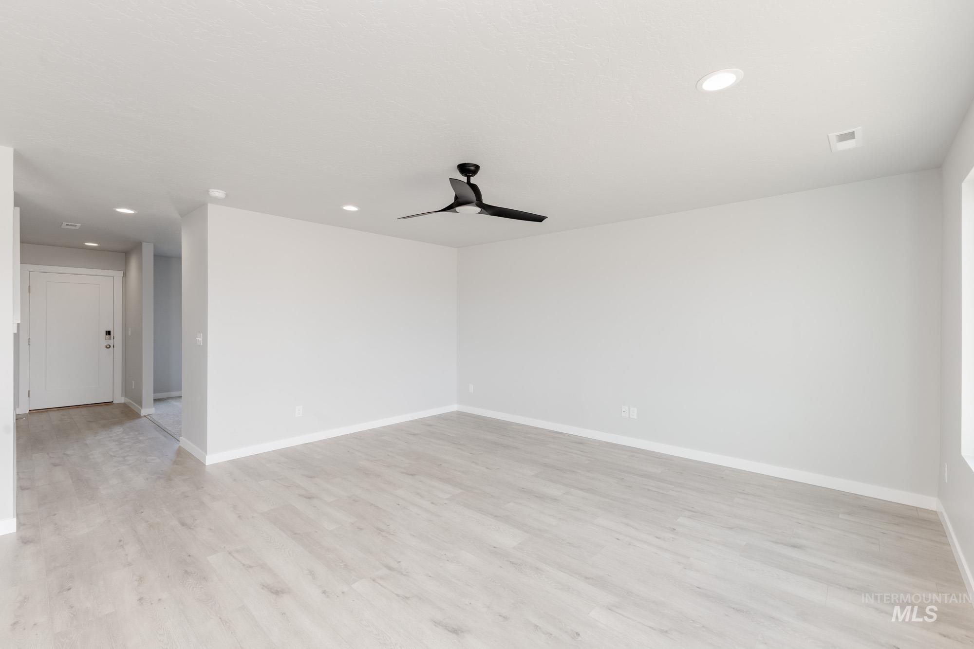 Spare room featuring recessed lighting, a ceiling fan, and light wood-type flooring
