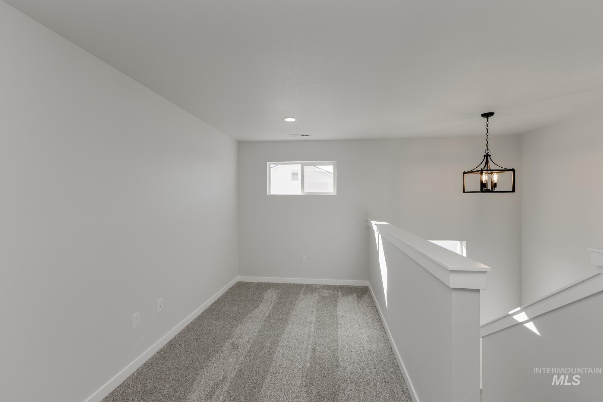 Empty room with carpet and baseboards