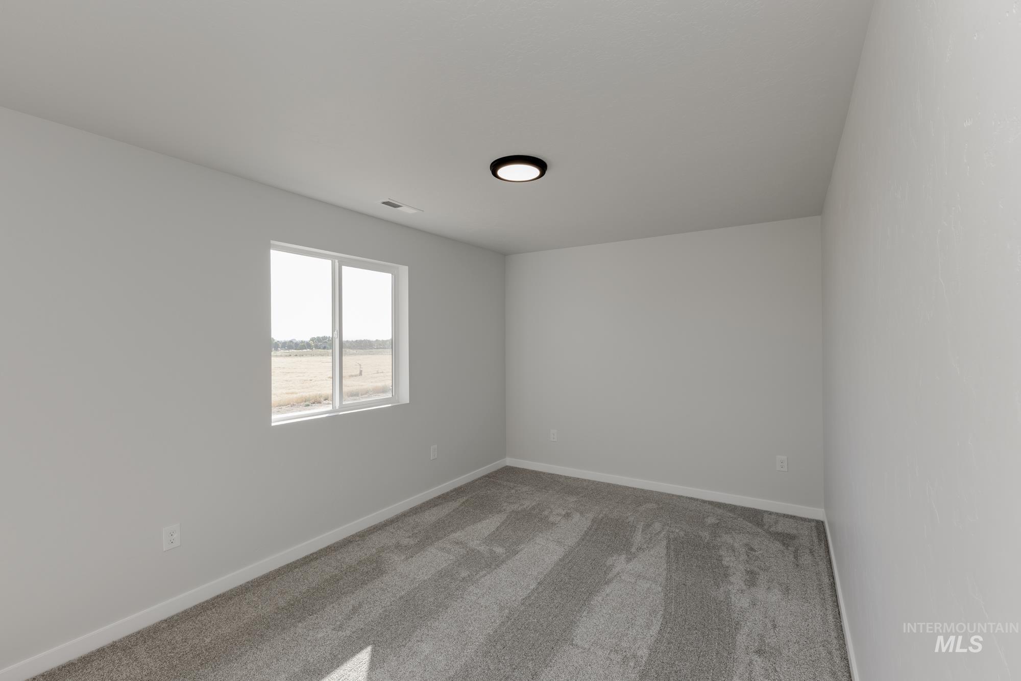 Spare room with carpet flooring and baseboards