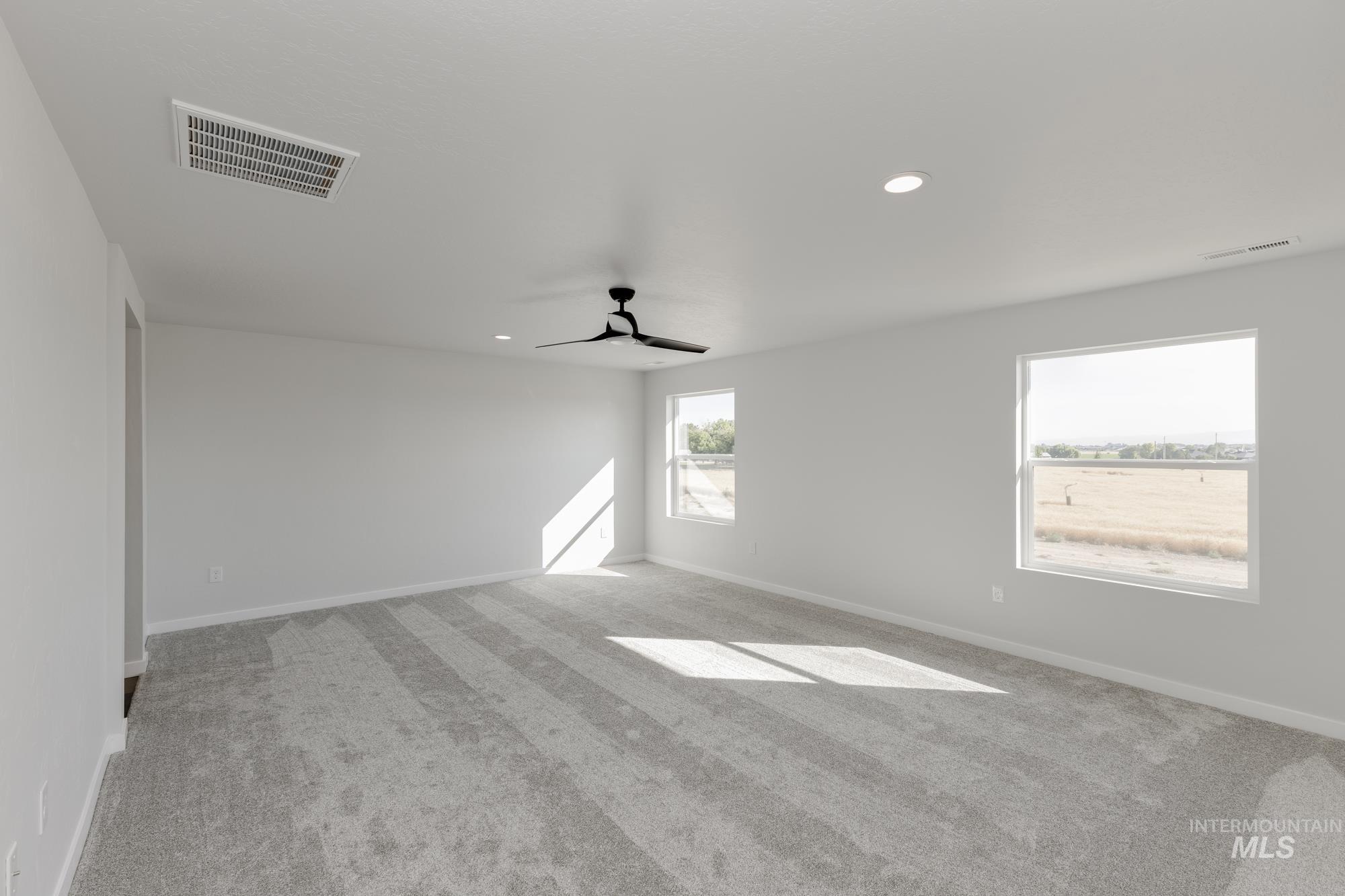 Unfurnished room with light colored carpet, recessed lighting, and a ceiling fan
