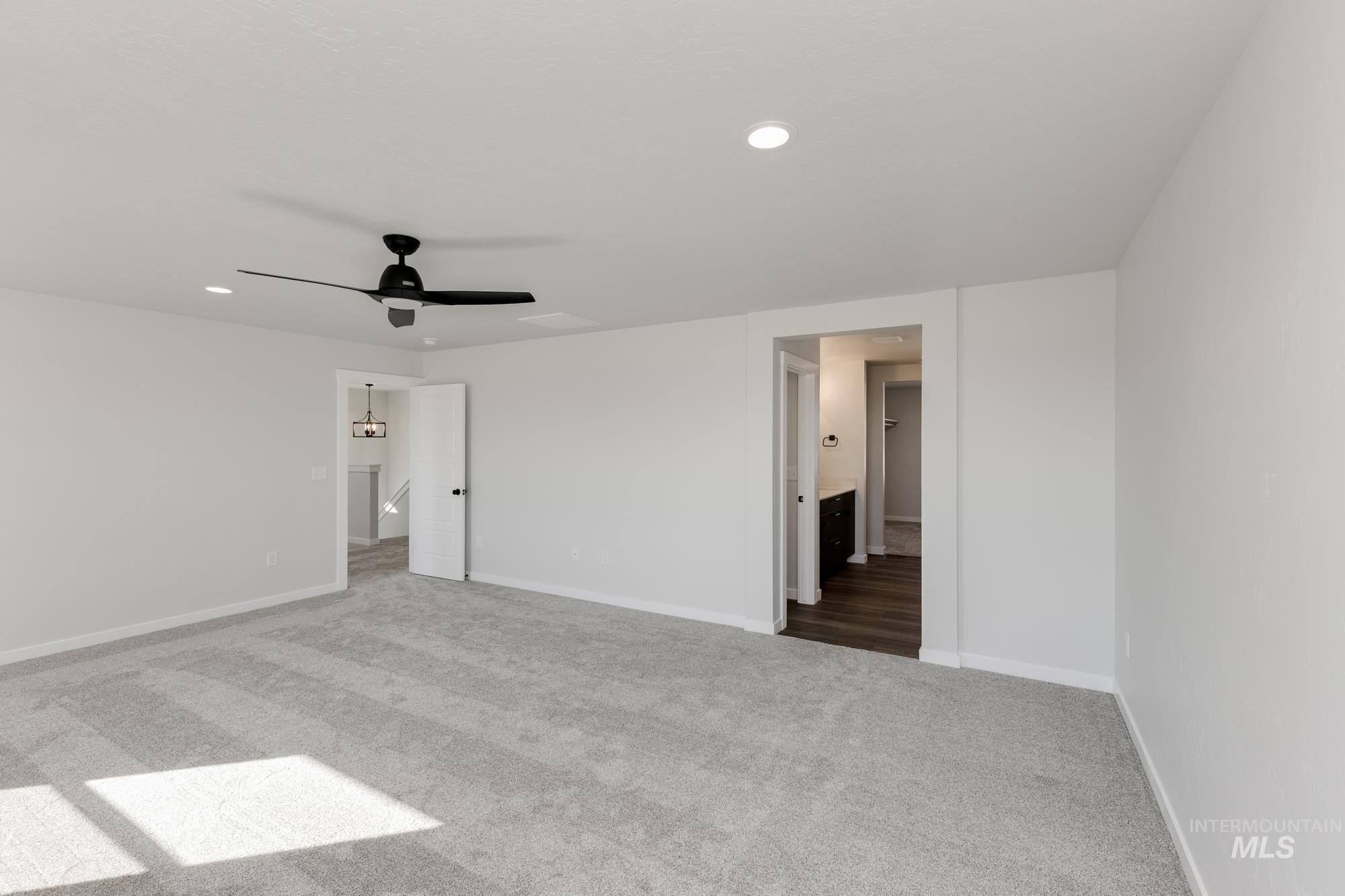 Unfurnished bedroom with carpet, recessed lighting, a ceiling fan, and connected bathroom