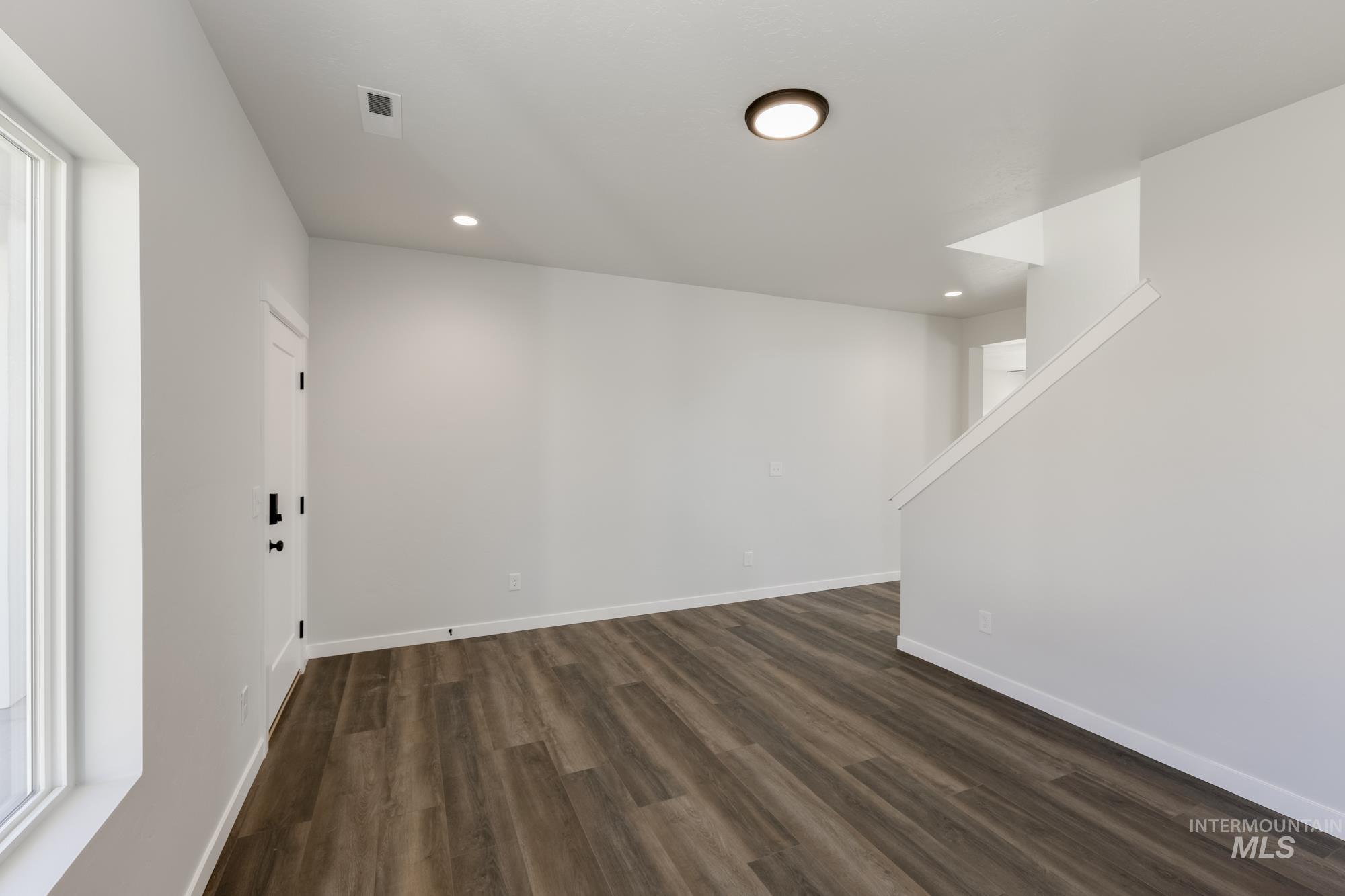 Basement featuring dark wood-style flooring and recessed lighting