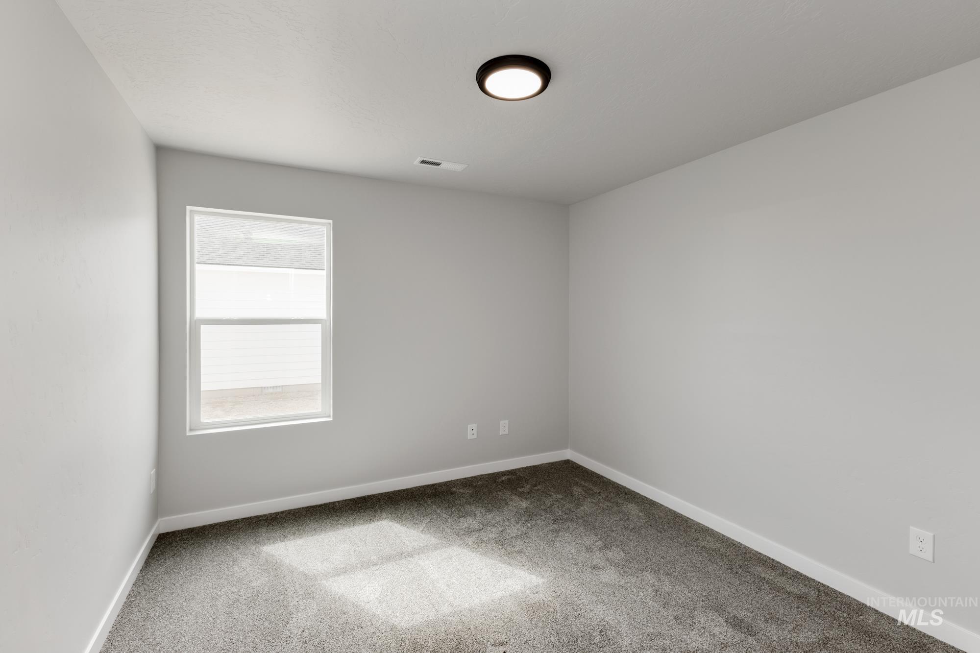Unfurnished room featuring carpet flooring and baseboards