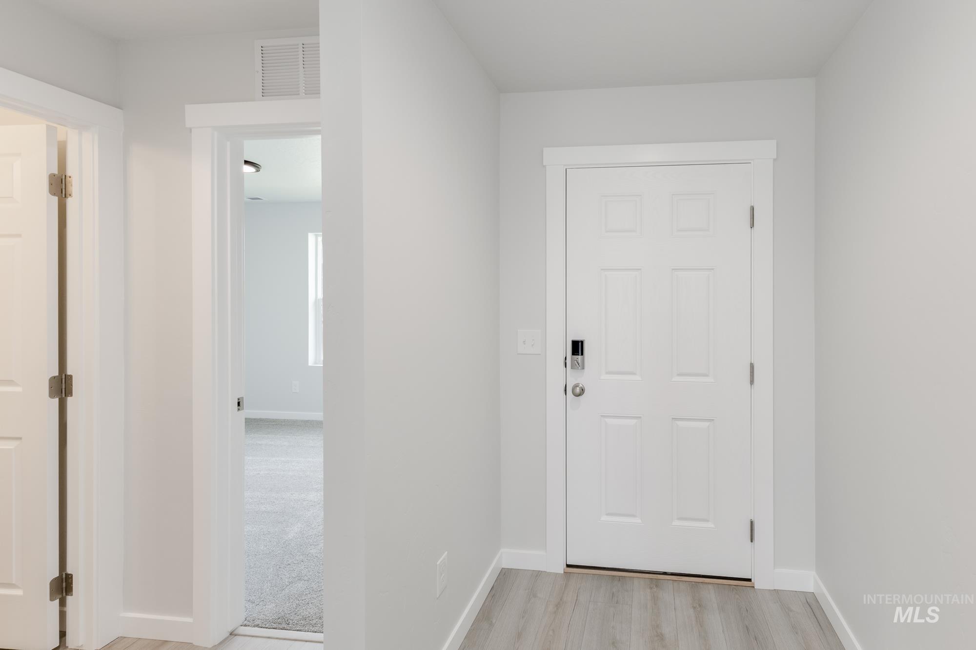 Foyer with light wood-style flooring