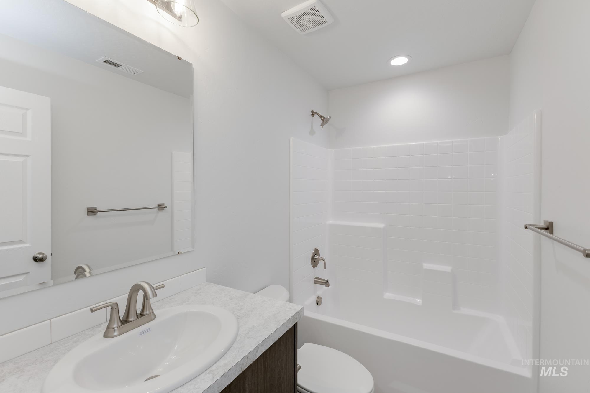 Full bathroom featuring vanity and shower / tub combination