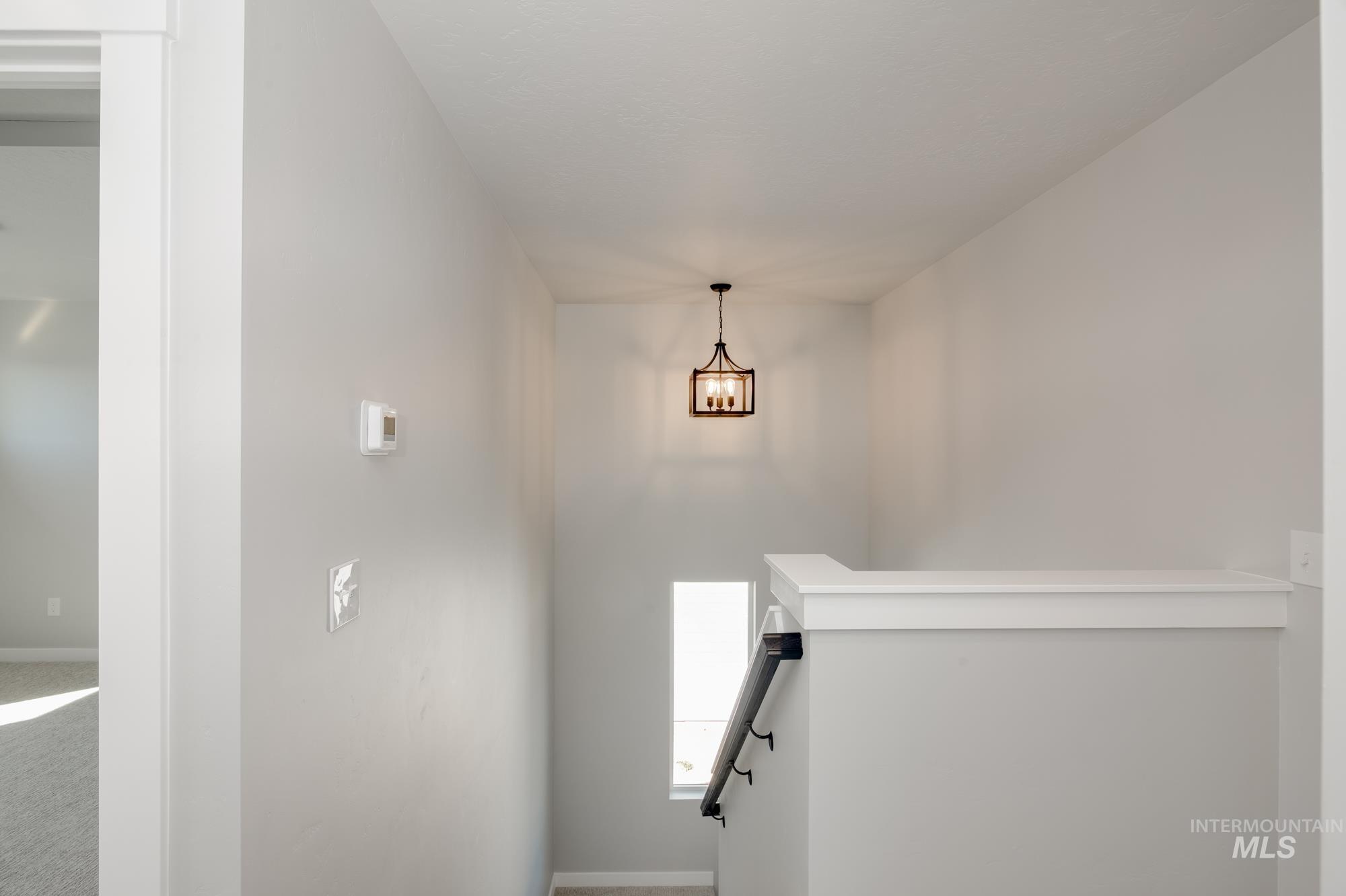 Stairway featuring carpet flooring and baseboards