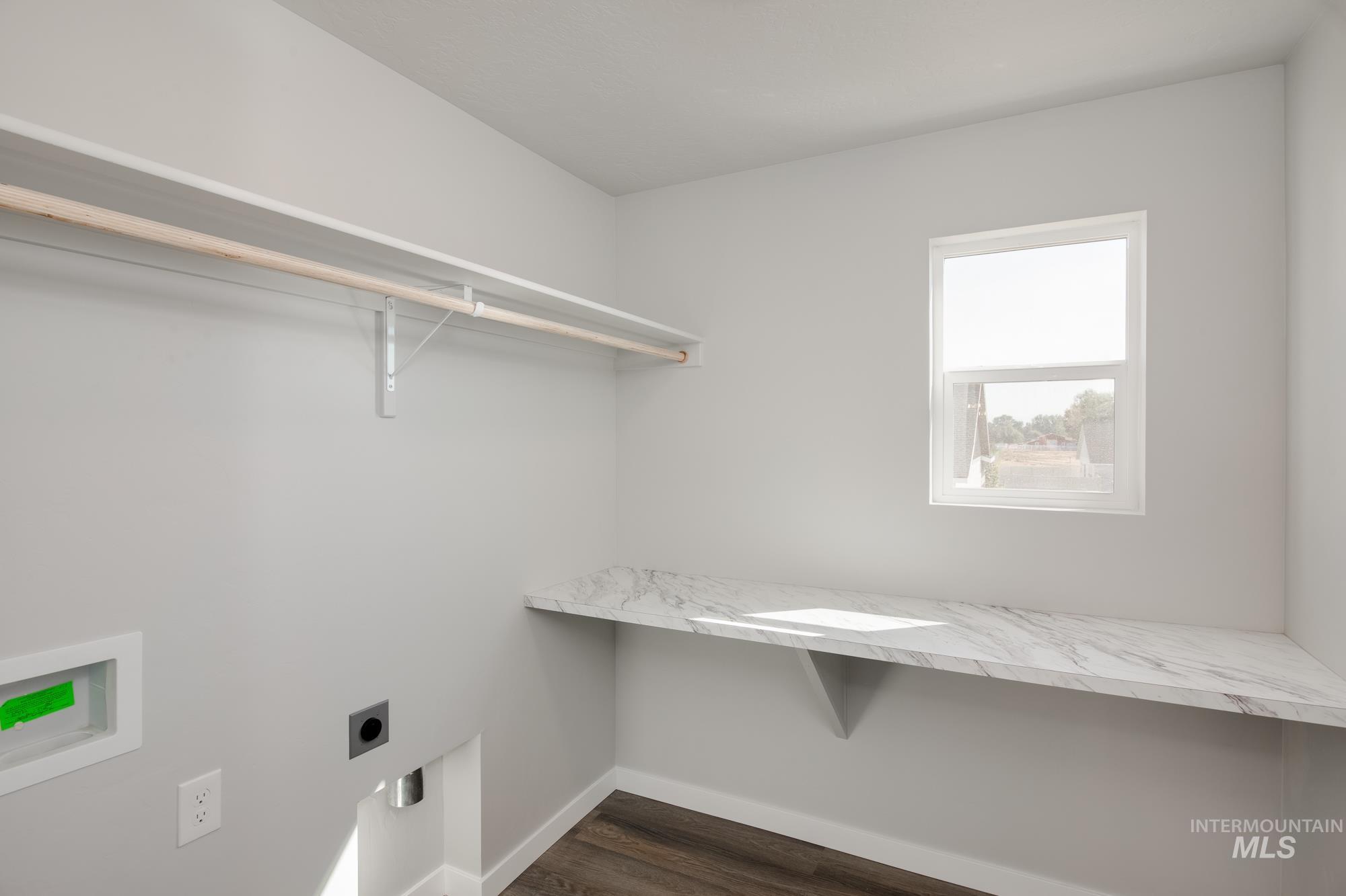 Laundry room with hookup for an electric dryer, dark wood-style floors, hookup for a washing machine, and a desk