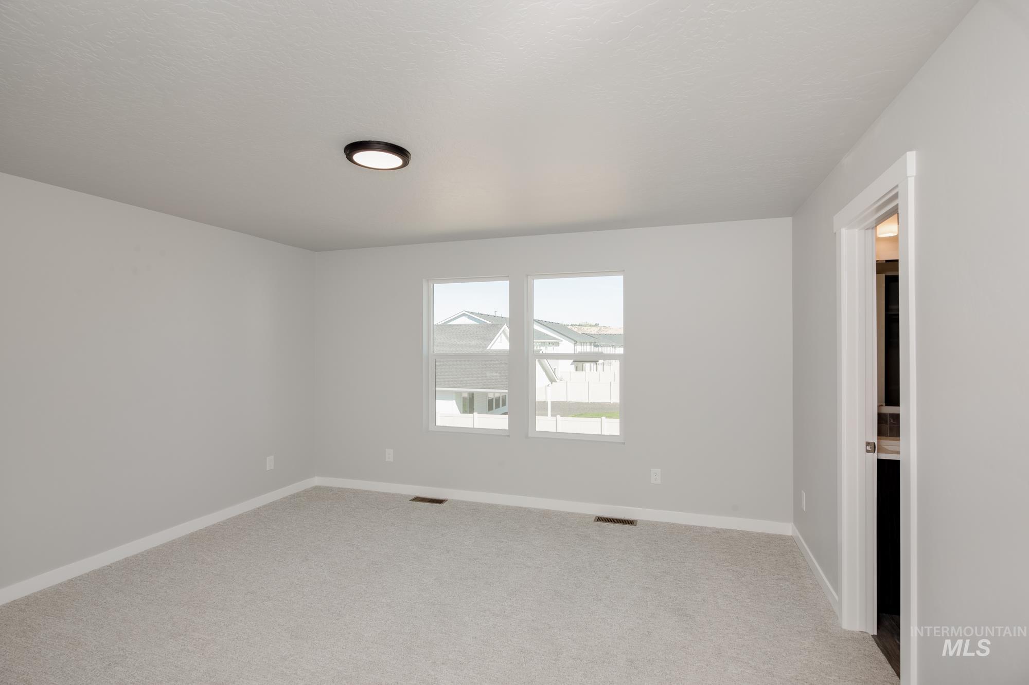 Unfurnished room with light carpet and baseboards