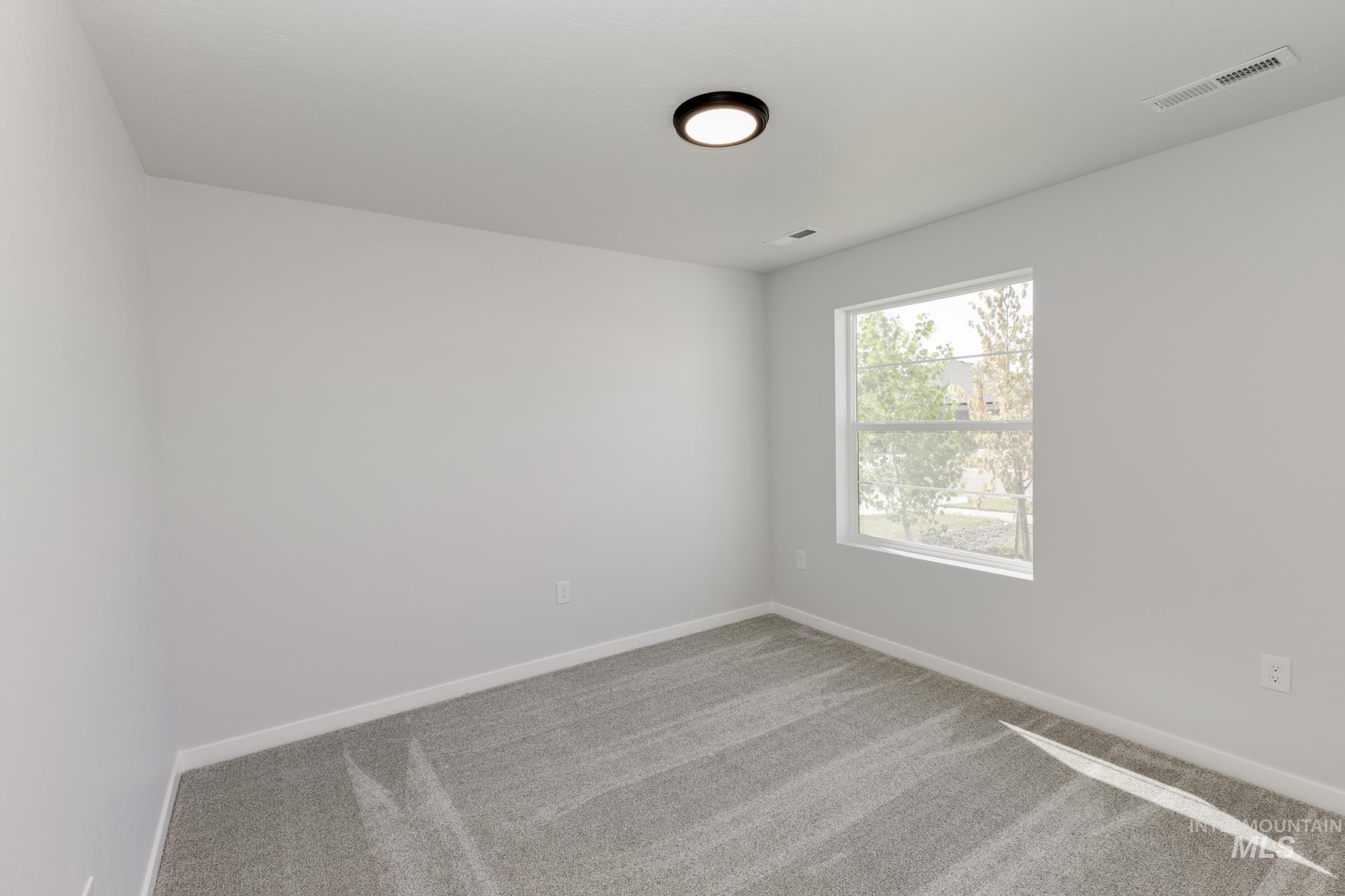 Empty room with carpet and baseboards