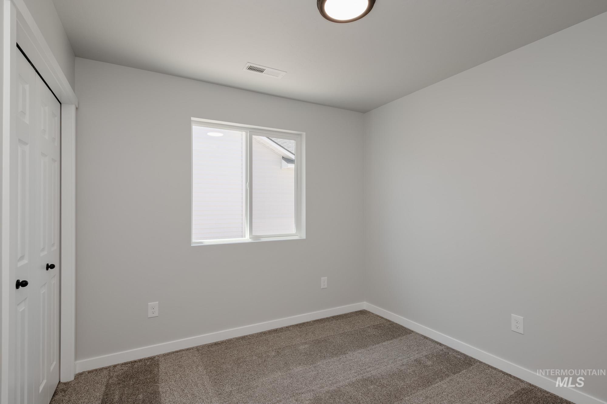 Unfurnished bedroom featuring carpet floors and a closet