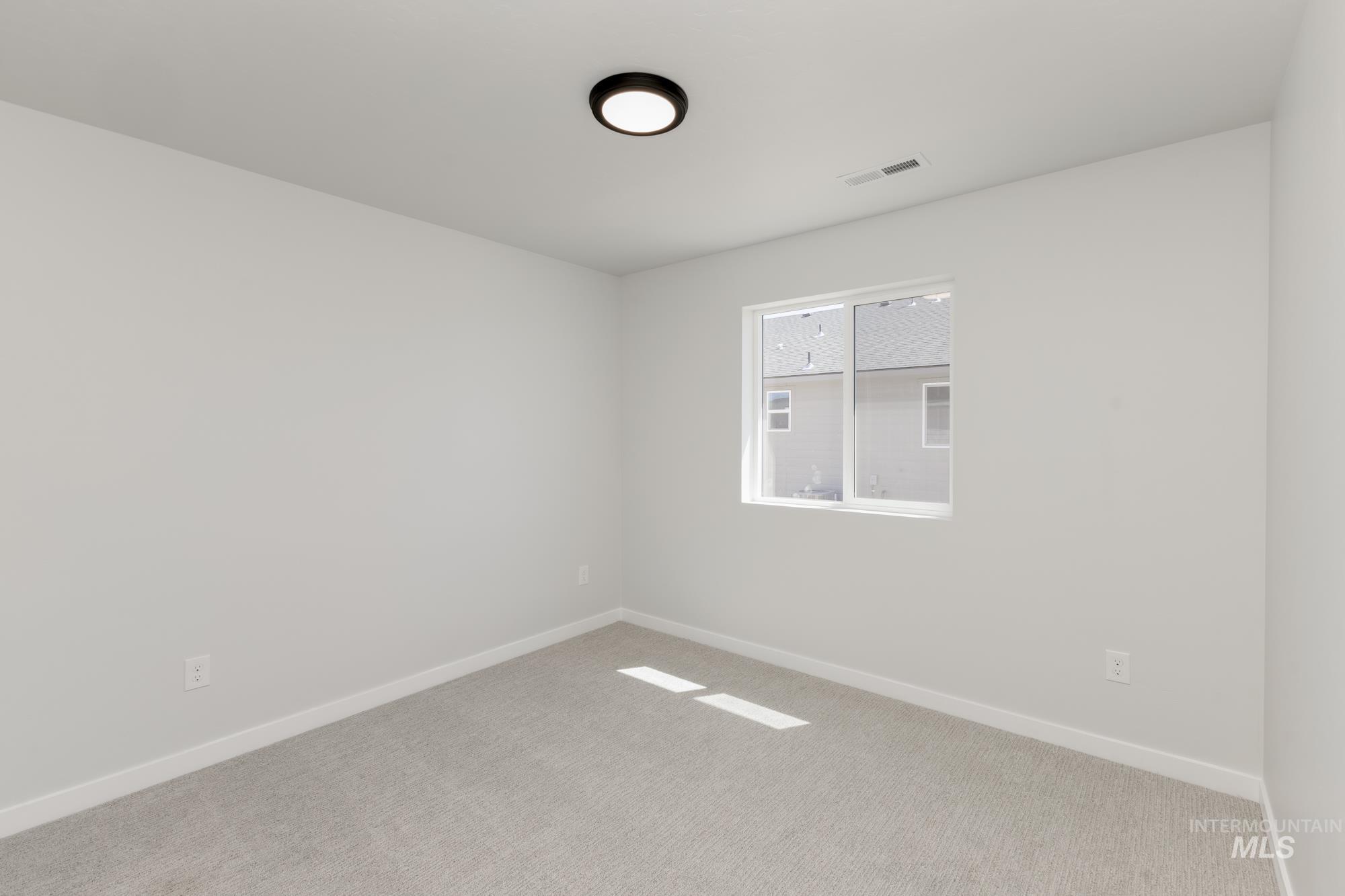 Empty room featuring baseboards and carpet