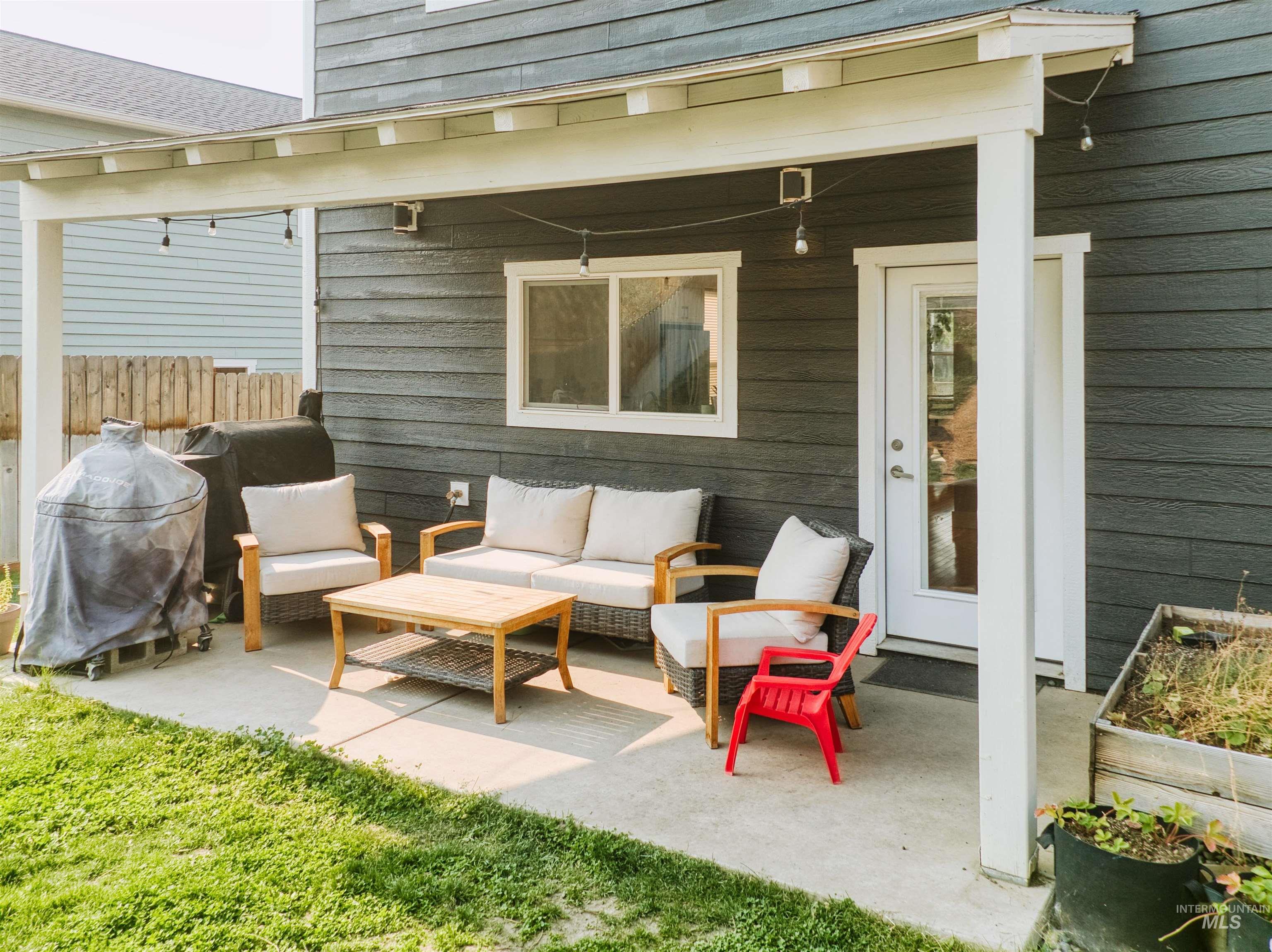 View of patio with a grill and an outdoor hangout area