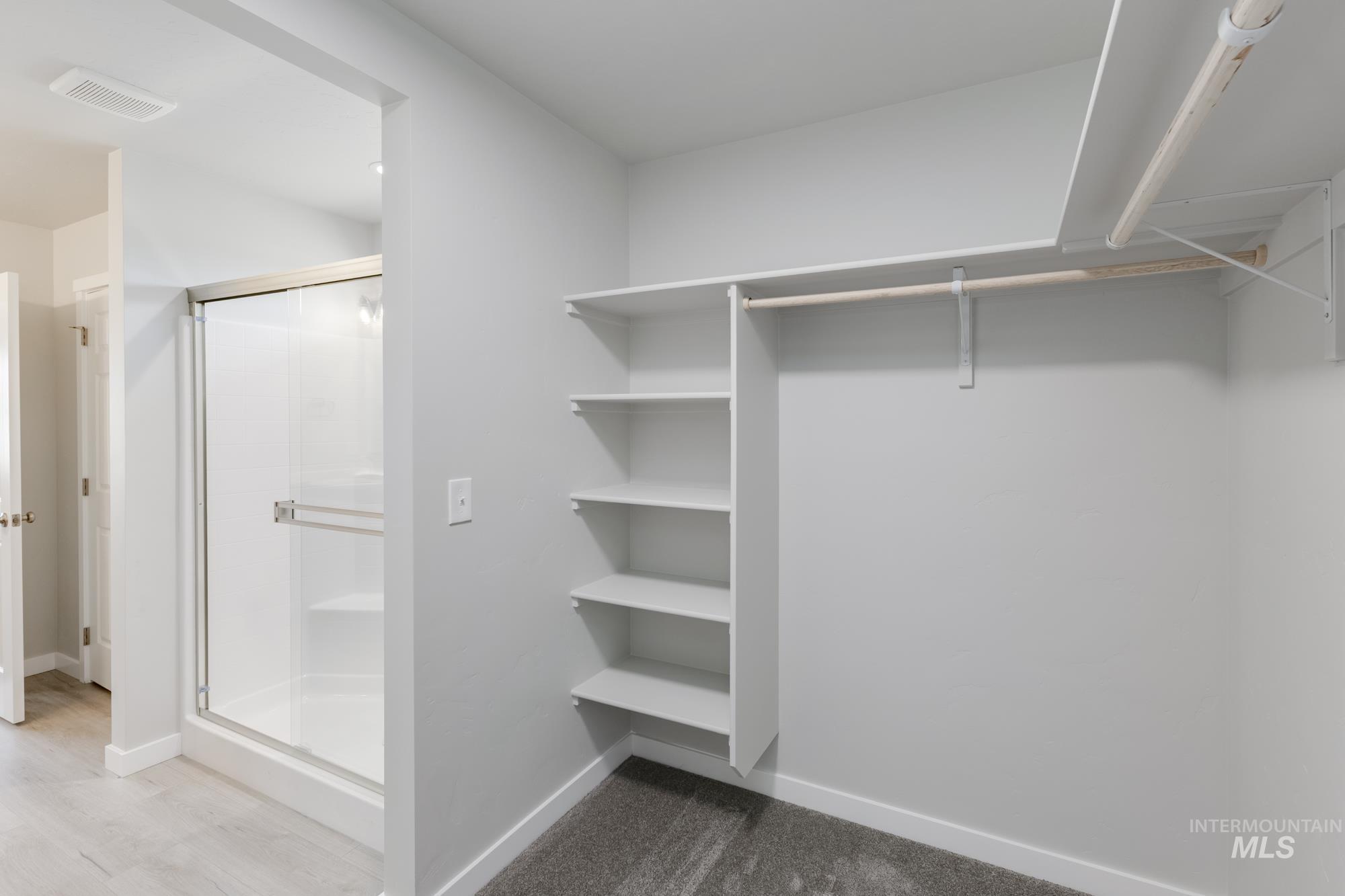 Spacious closet with light wood-style floors