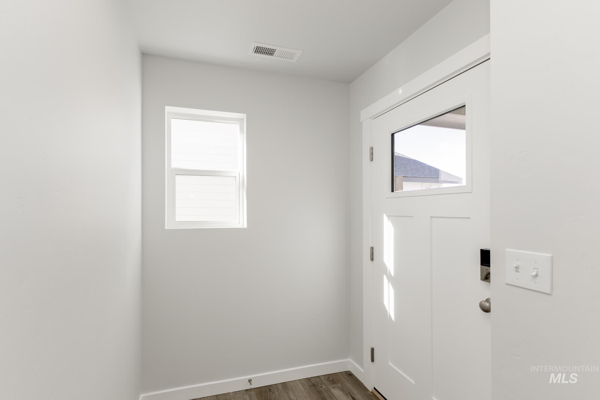 Entrance foyer with healthy amount of natural light and wood finished floors