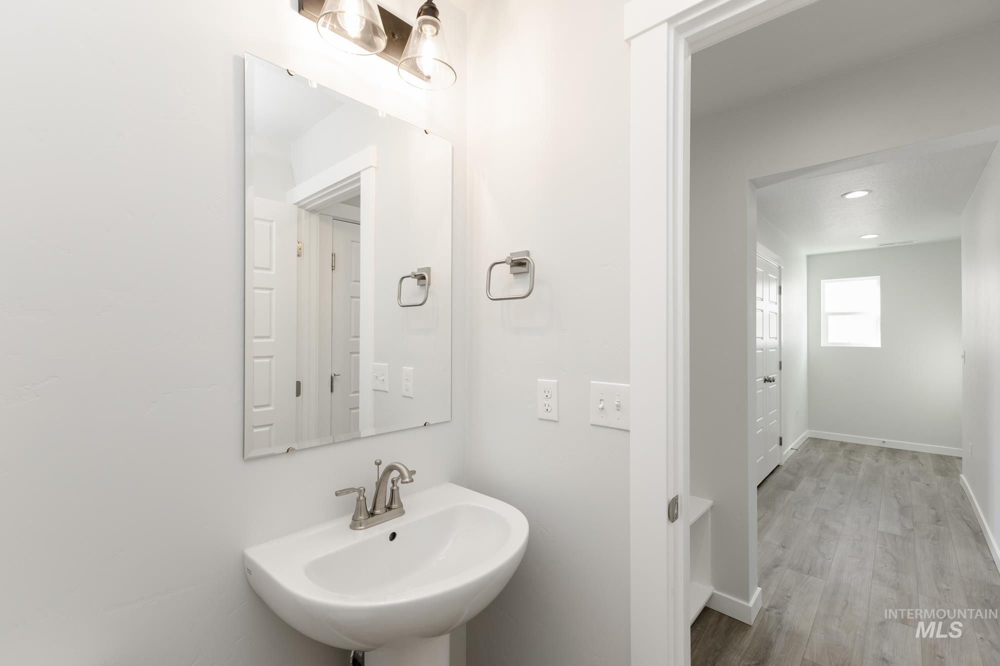Bathroom featuring wood finished floors and recessed lighting