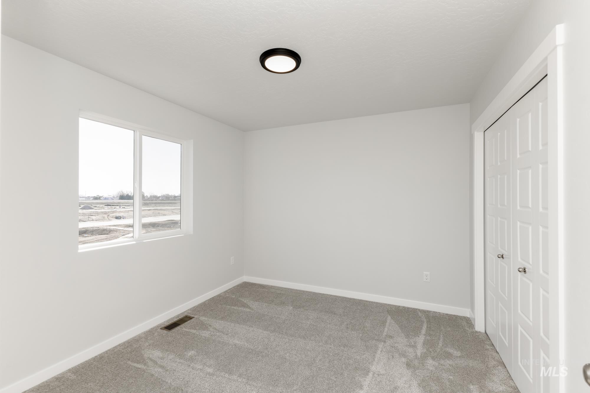 Unfurnished bedroom featuring carpet flooring and a closet
