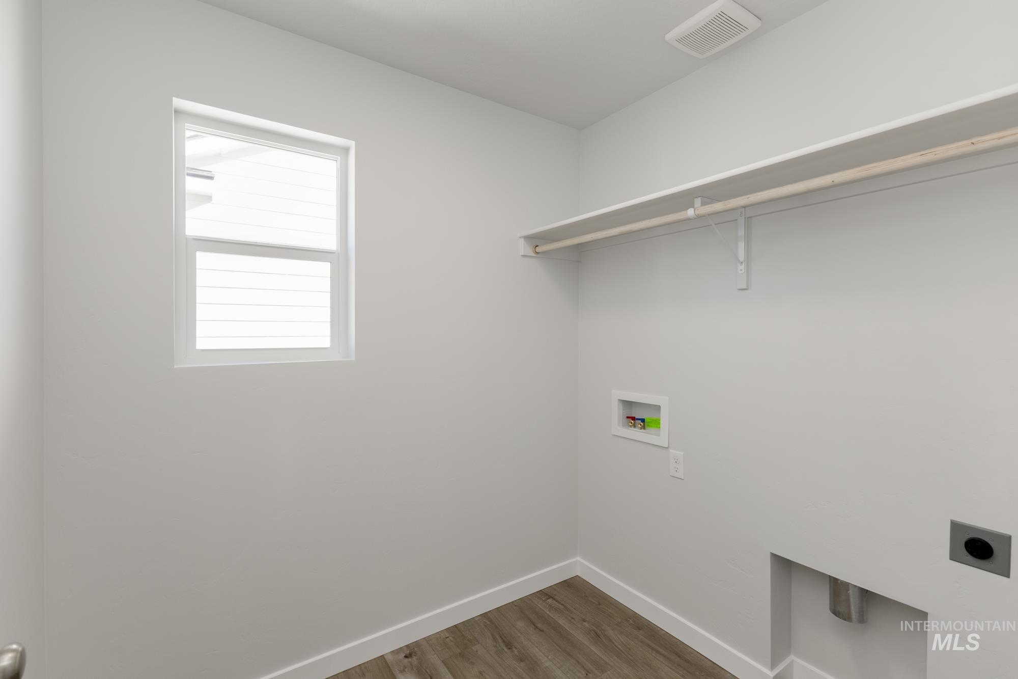 Washroom featuring electric dryer hookup, washer hookup, and dark wood-type flooring