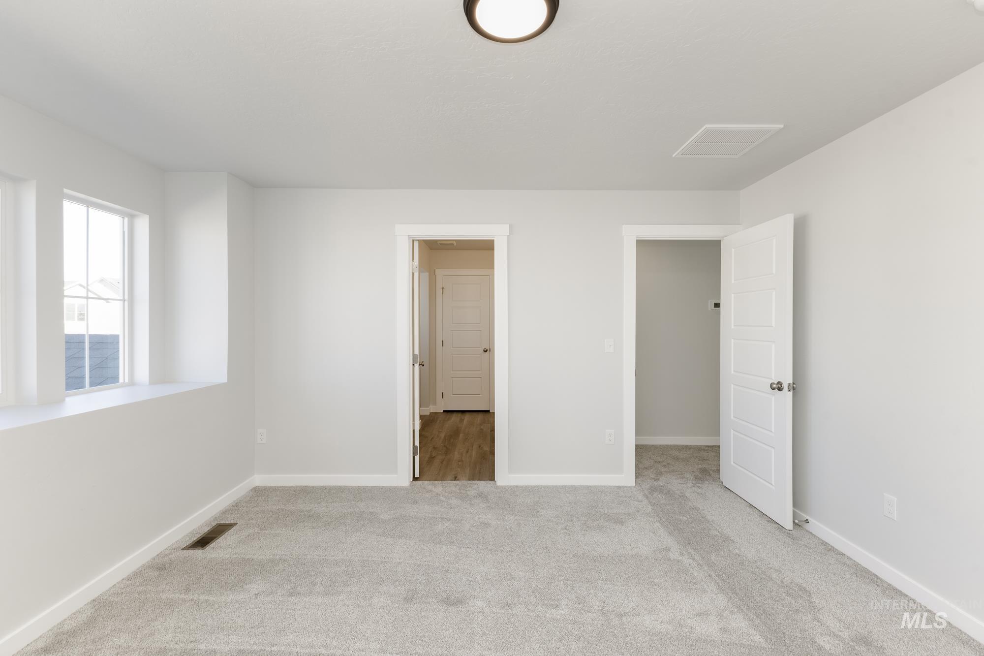 Unfurnished bedroom with carpet and baseboards