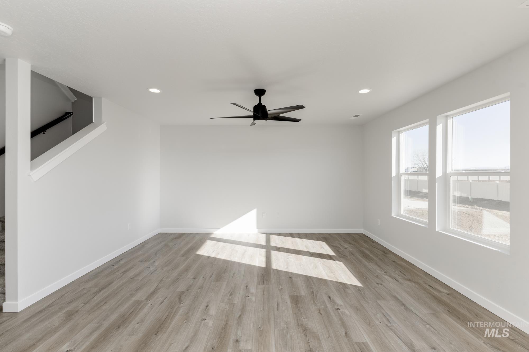 Empty room featuring wood finished floors, recessed lighting, and a ceiling fan