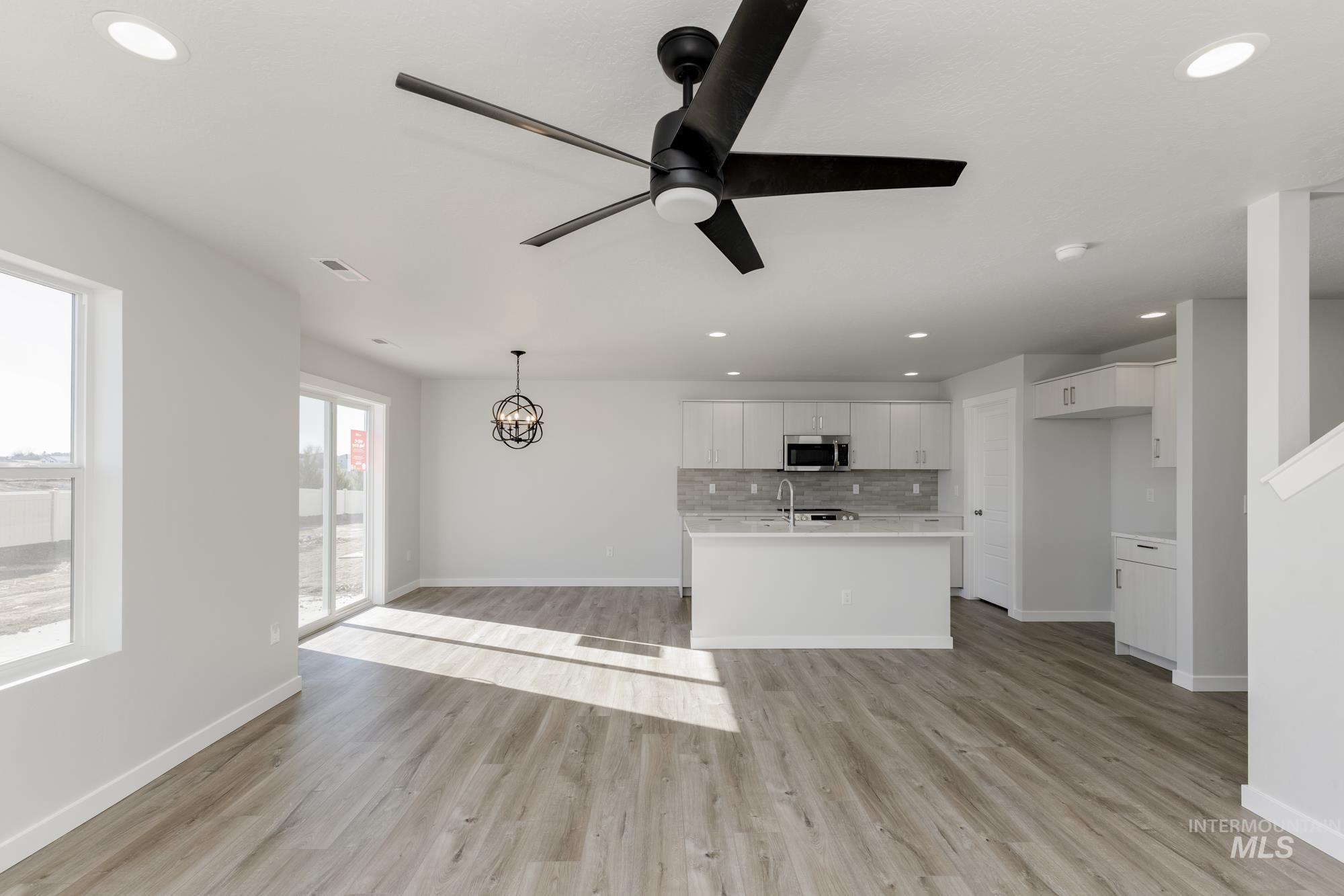 Unfurnished living room featuring light wood-type flooring, recessed lighting, and ceiling fan