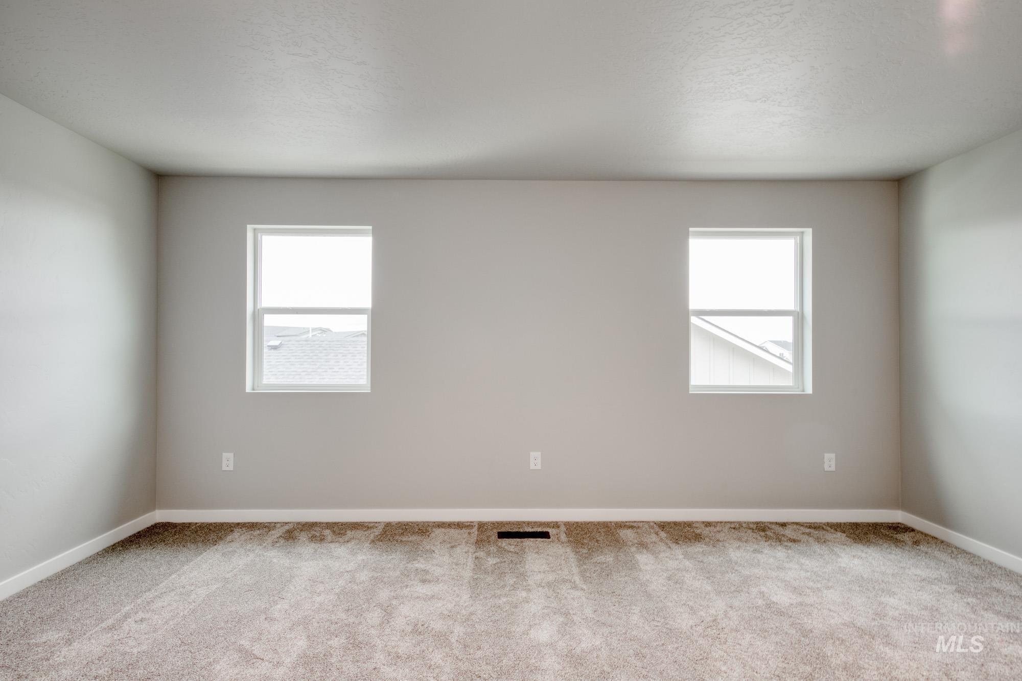 Spare room with carpet and plenty of natural light