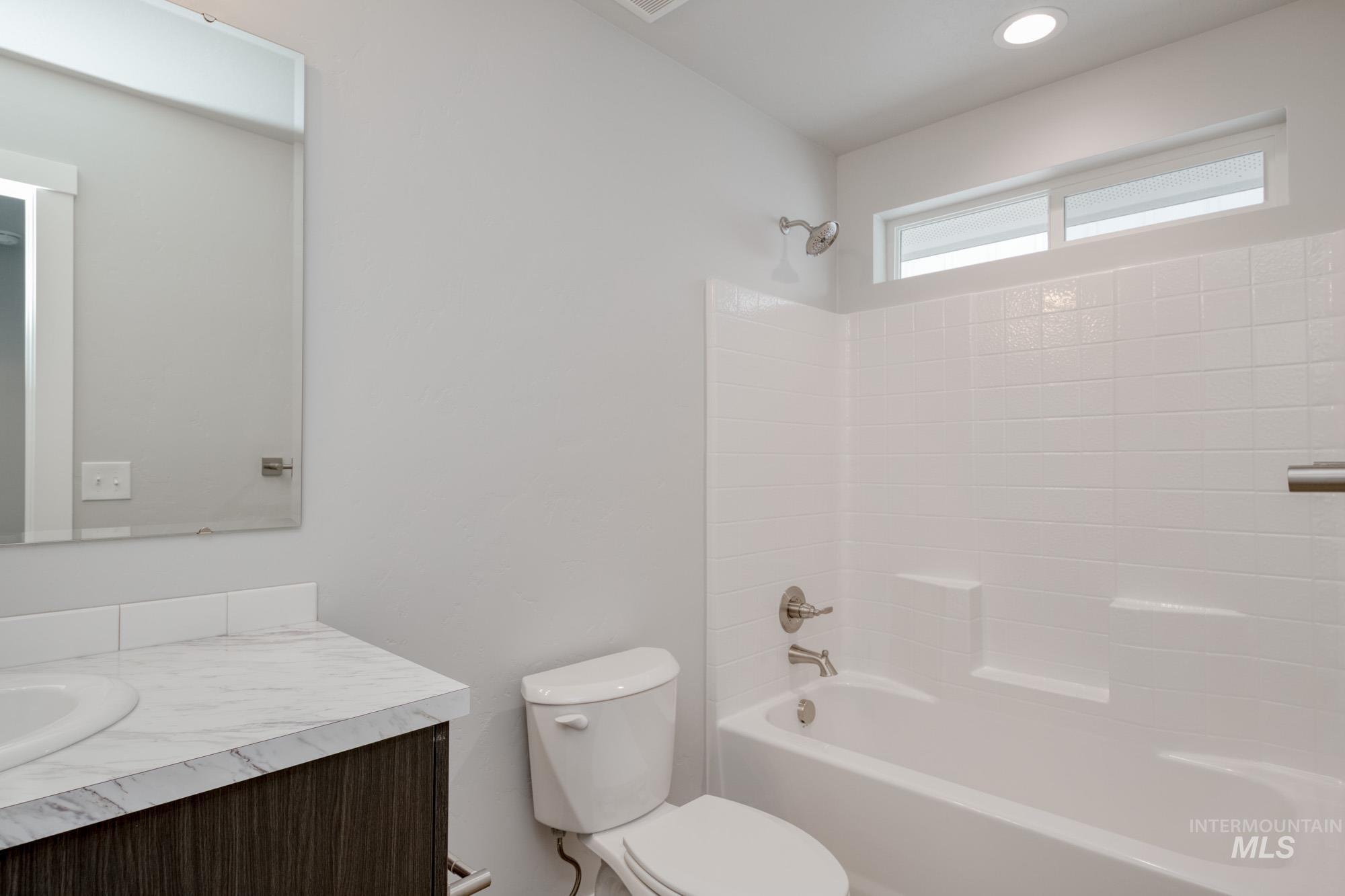 Bathroom with vanity and shower / tub combination