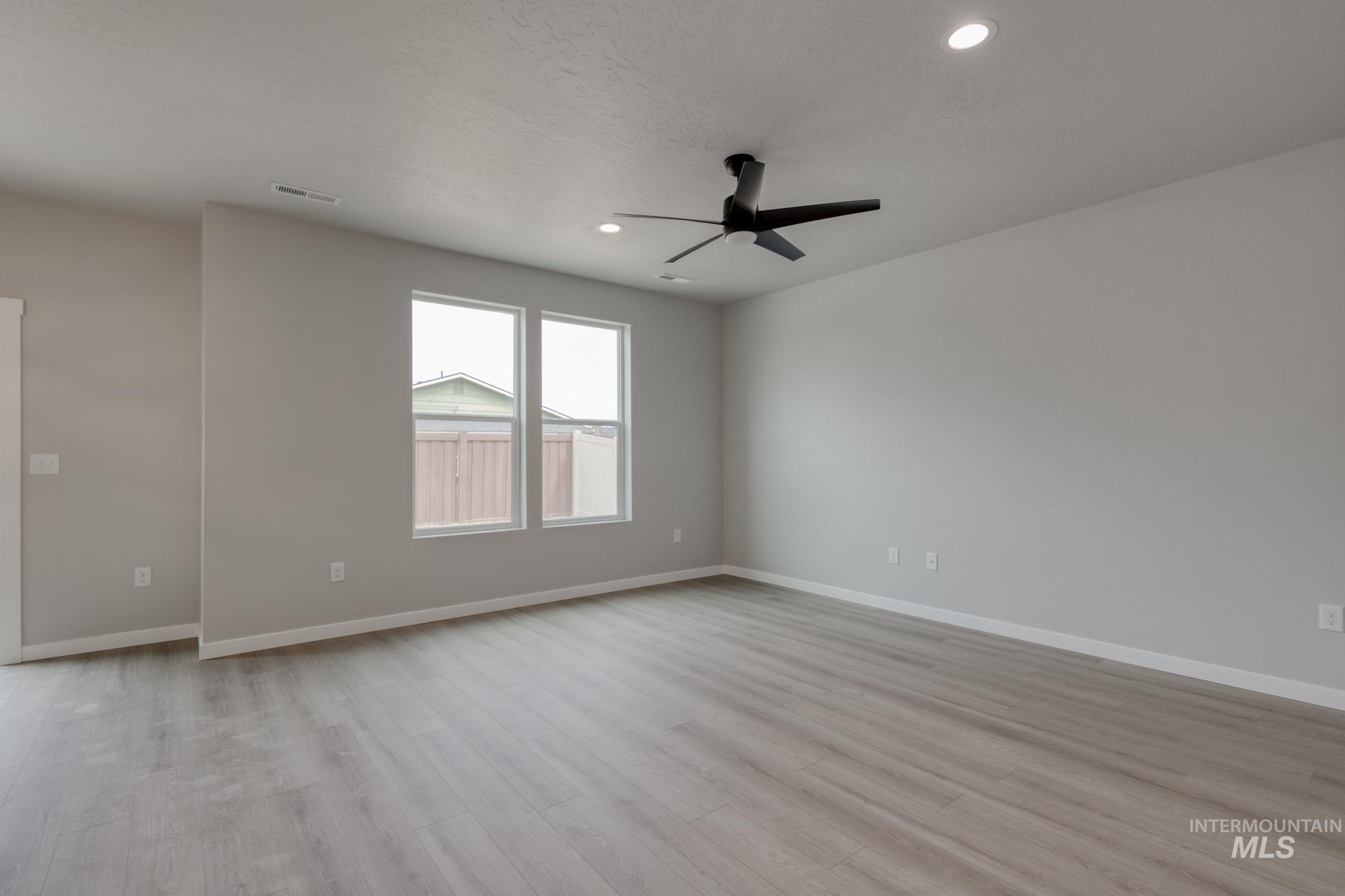 Spare room with ceiling fan, light wood-style flooring, recessed lighting, and a textured ceiling