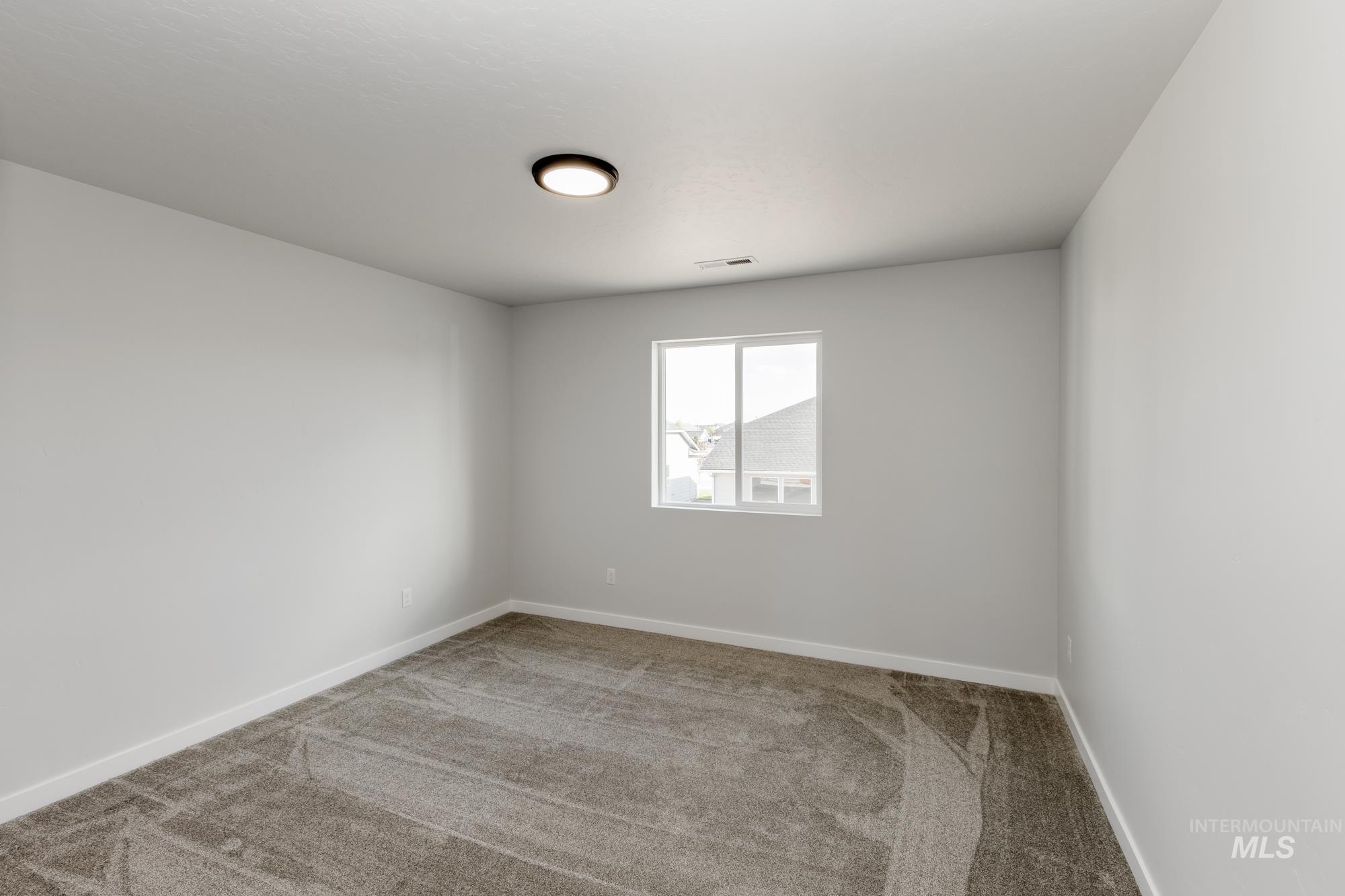 Unfurnished room featuring carpet flooring and baseboards