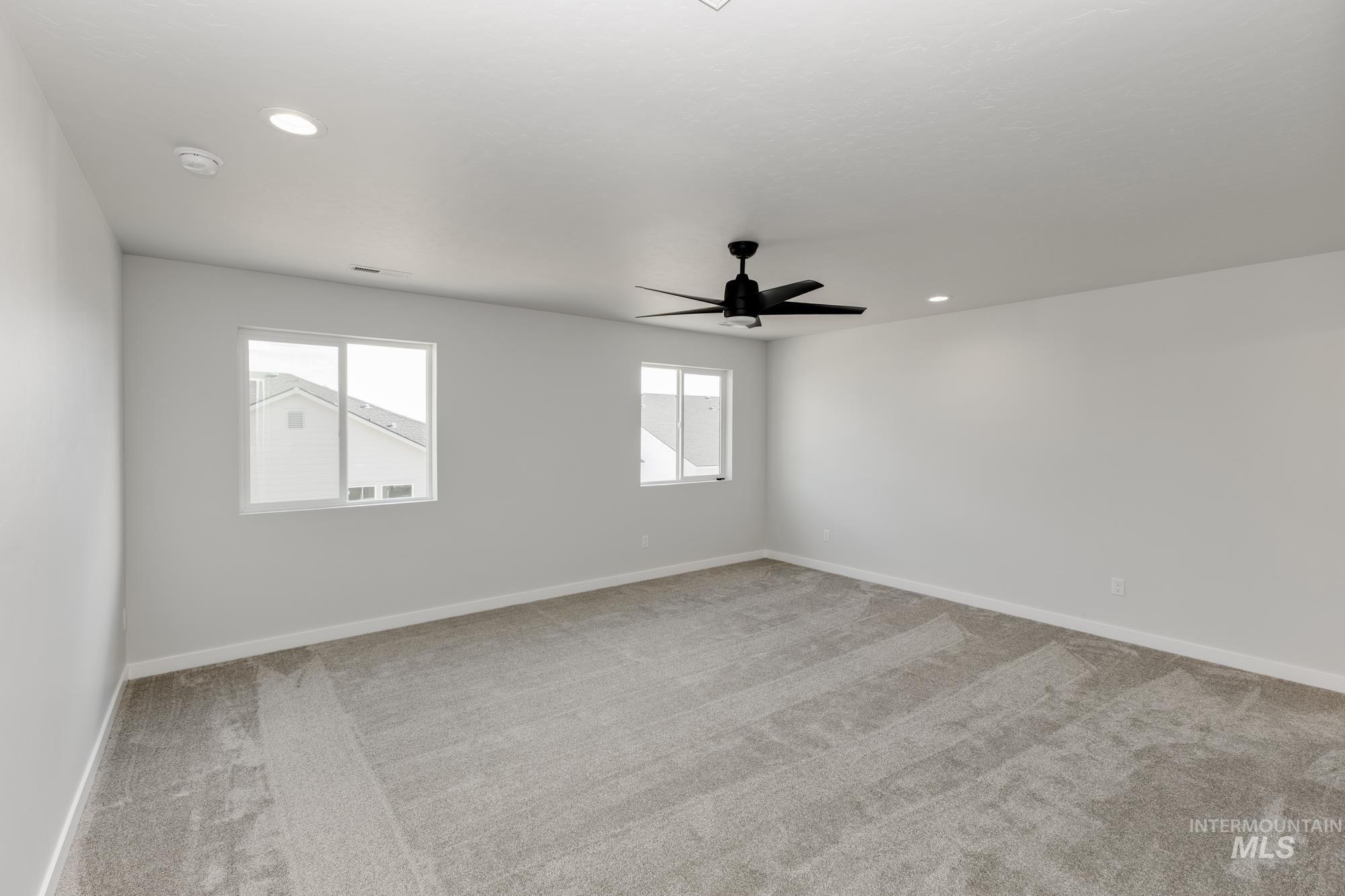Empty room featuring recessed lighting, carpet flooring, and a ceiling fan