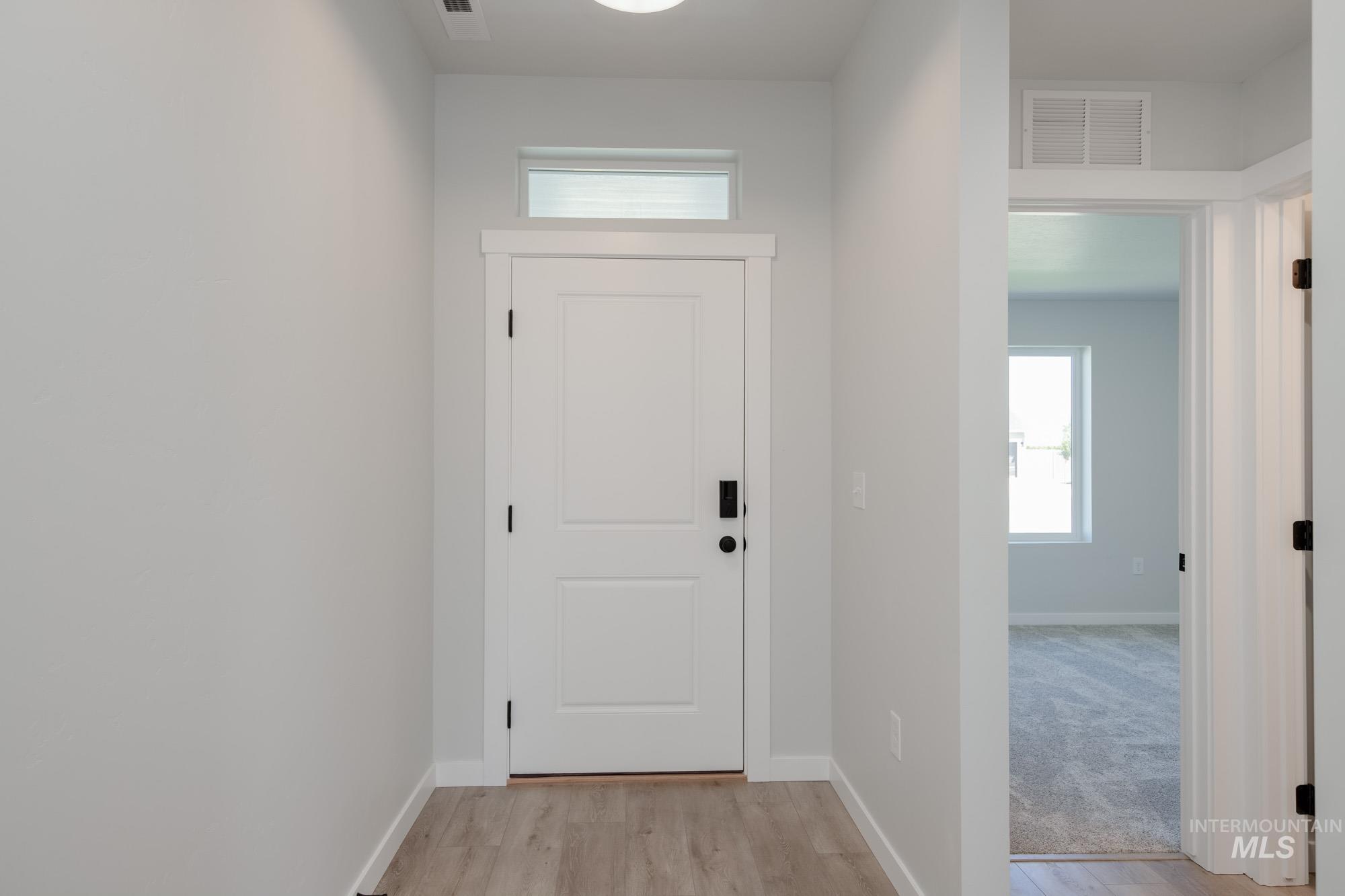 Entrance foyer with light wood-style flooring