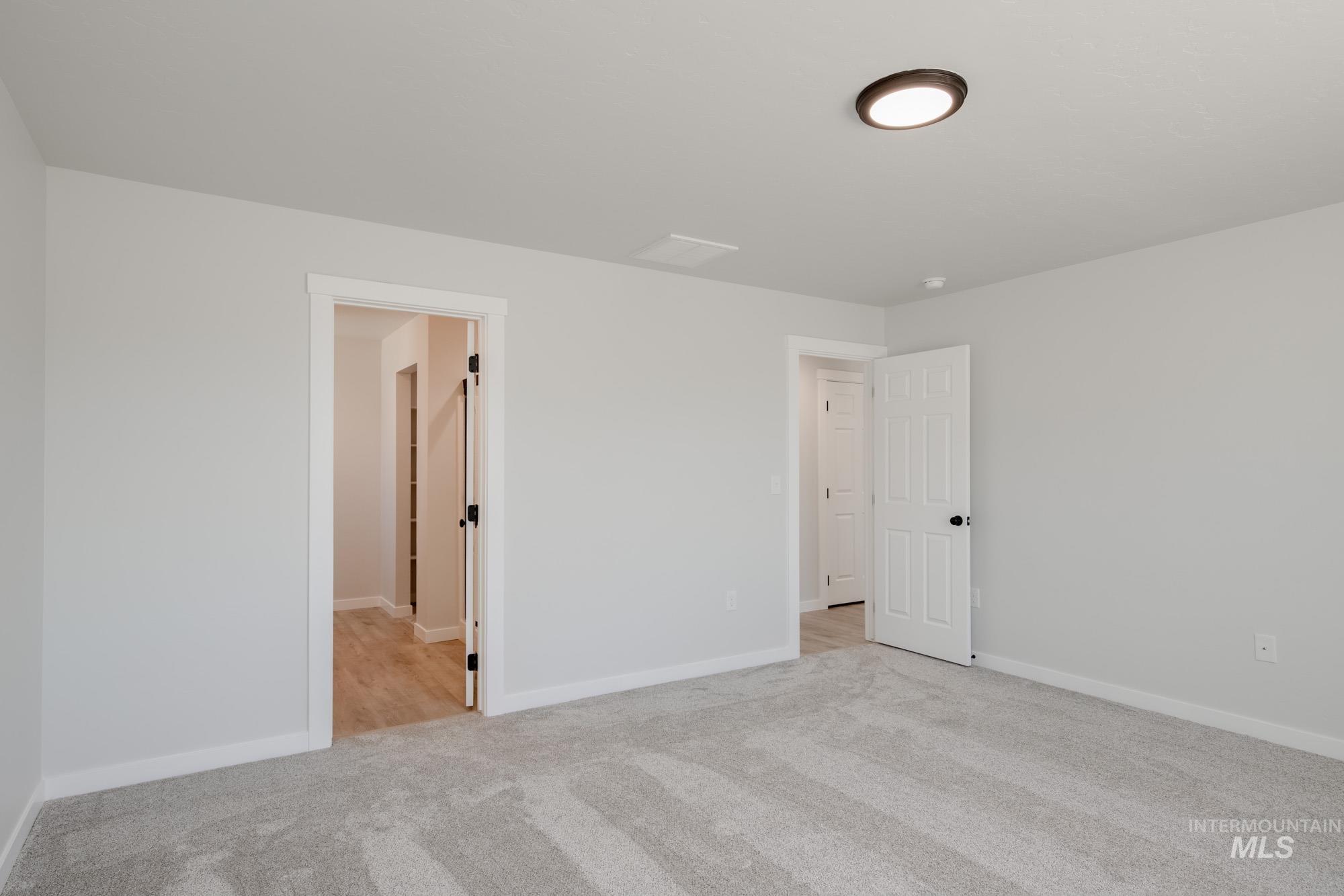 Unfurnished bedroom featuring carpet and baseboards