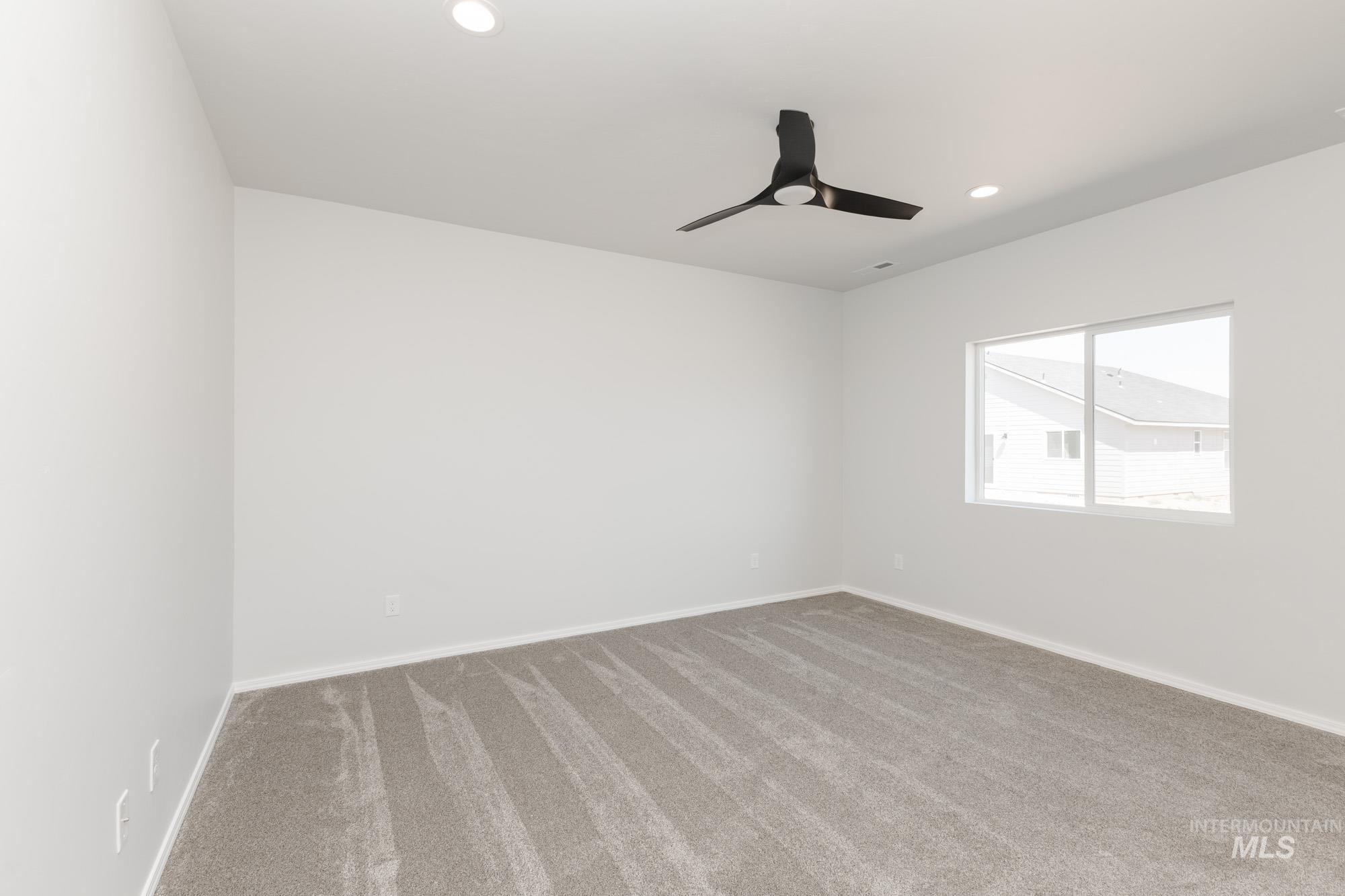 Carpeted empty room with recessed lighting and ceiling fan