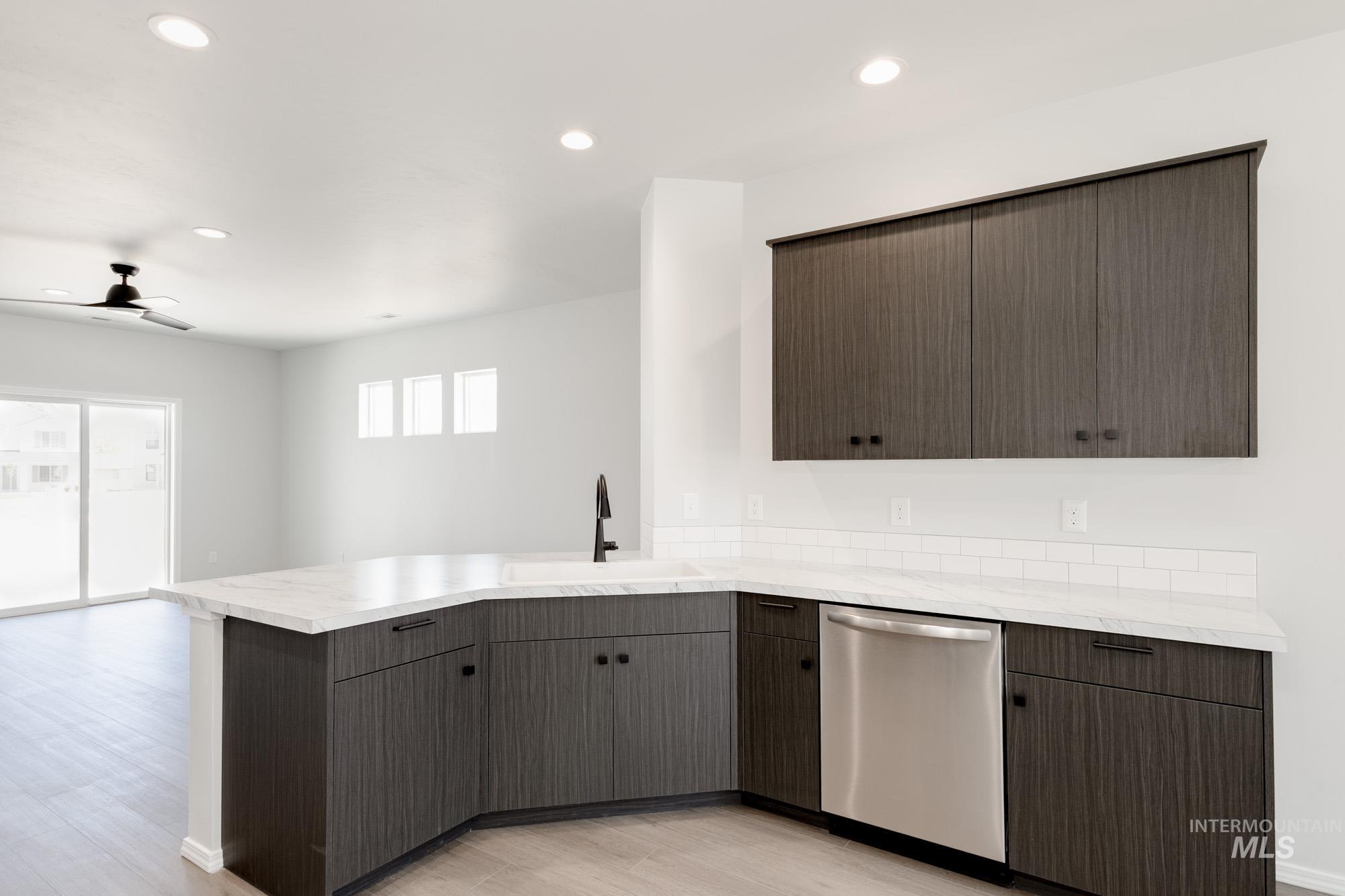 Kitchen with dishwasher, recessed lighting, a ceiling fan, a peninsula, and light wood-type flooring