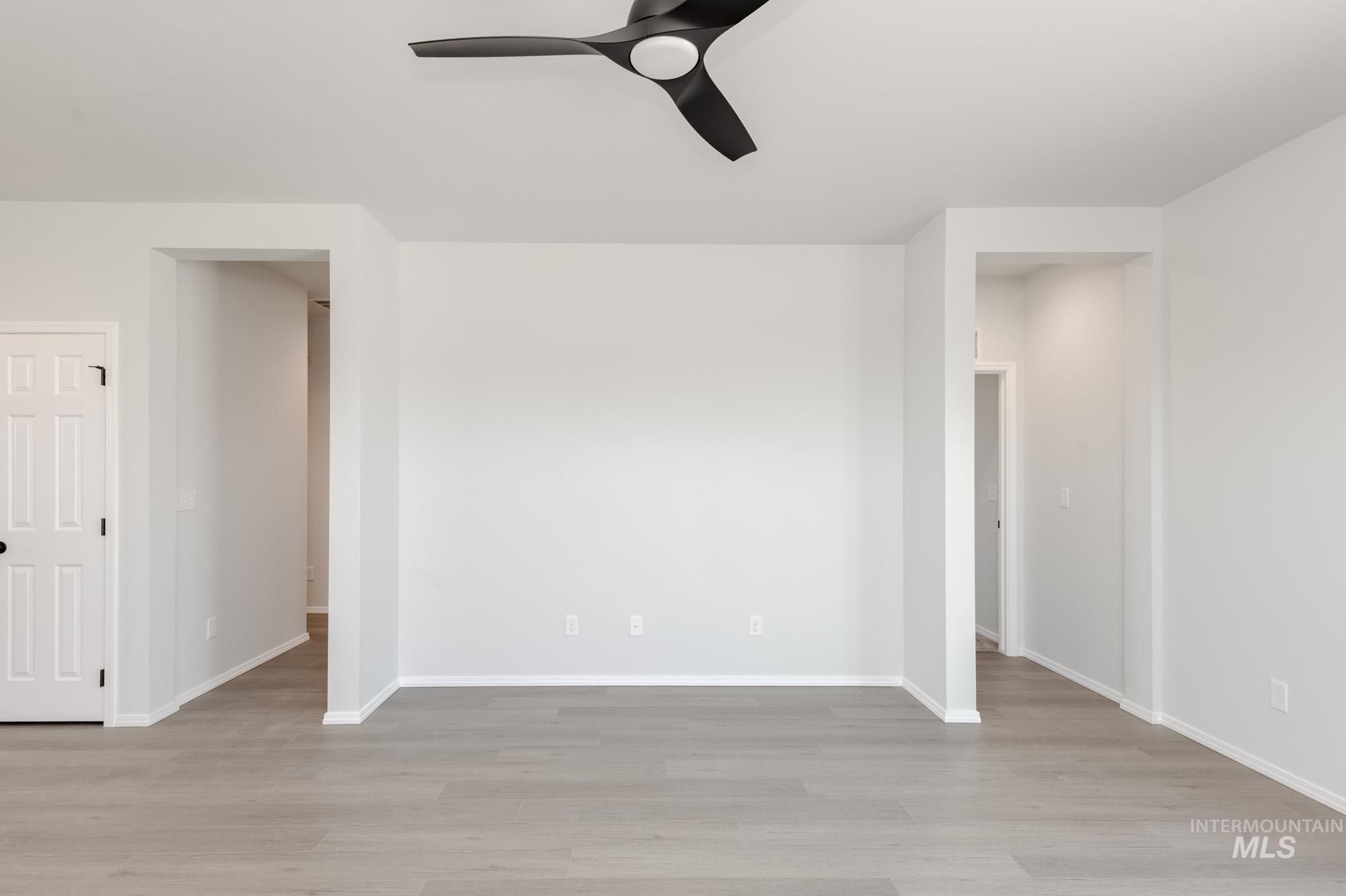 Unfurnished room with light wood finished floors and a ceiling fan