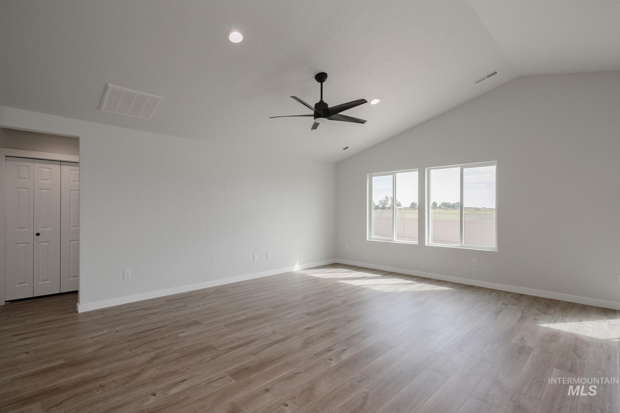 Spare room featuring recessed lighting, light wood-style flooring, lofted ceiling, and ceiling fan