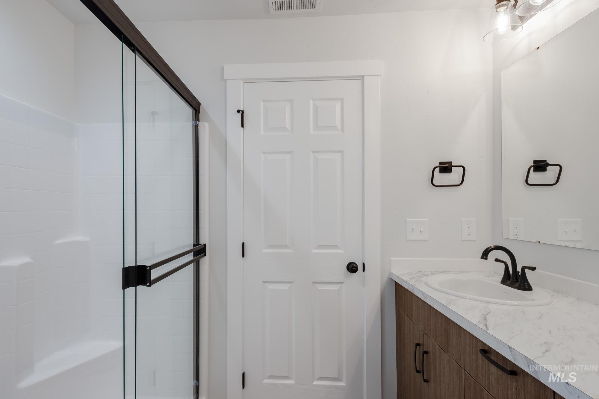 Full bathroom featuring vanity and a stall shower