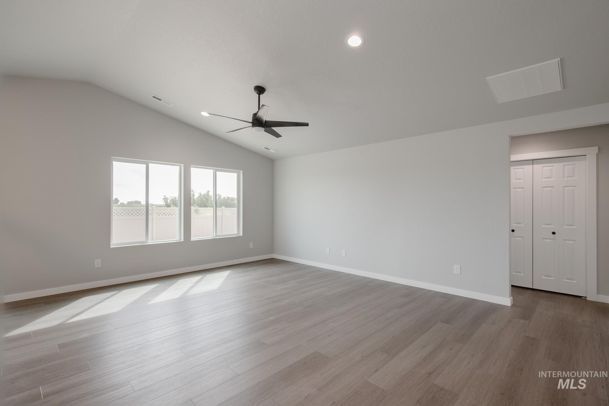 Spare room with lofted ceiling, light wood-type flooring, recessed lighting, and a ceiling fan