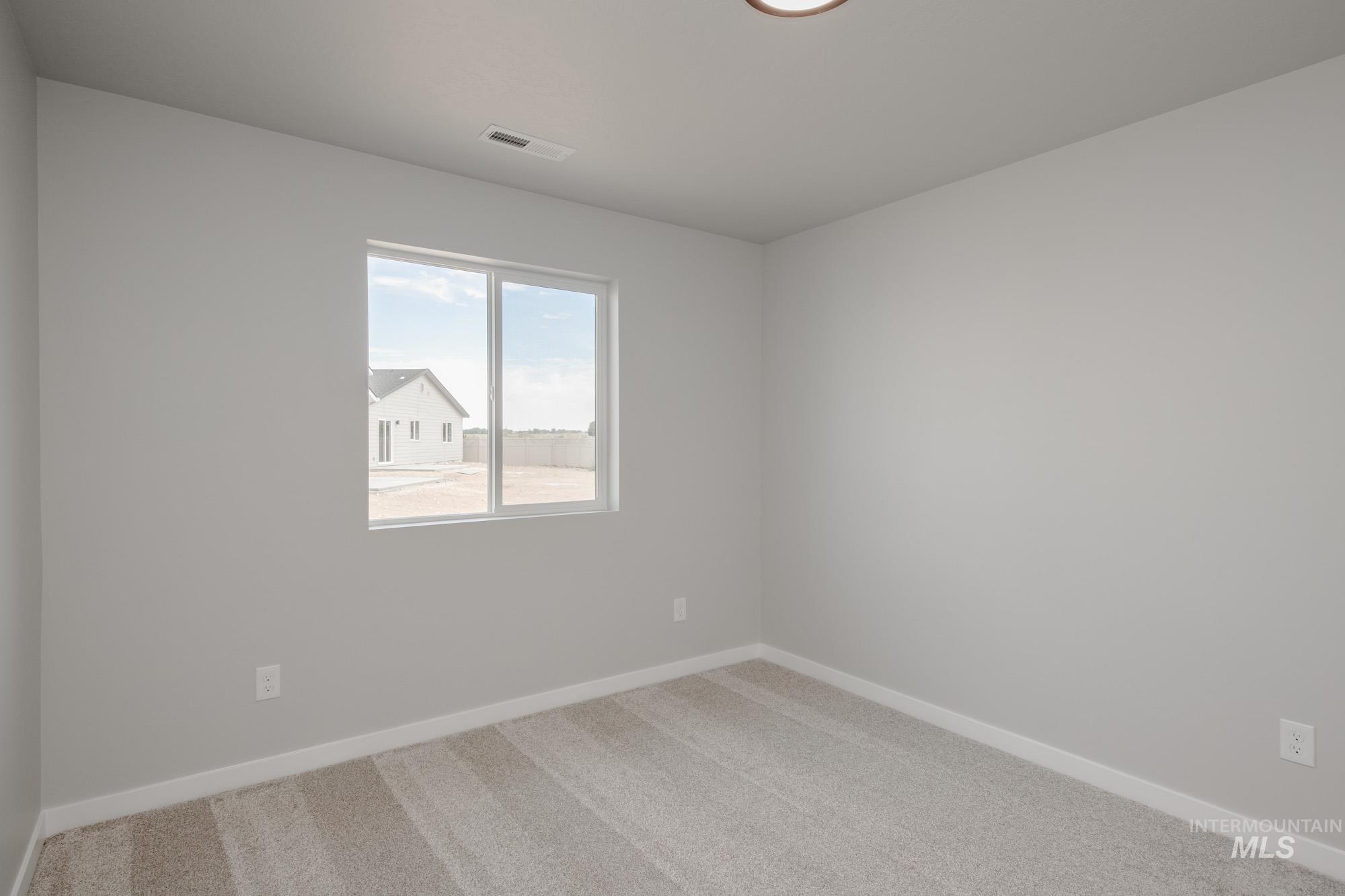 Spare room with carpet flooring and baseboards