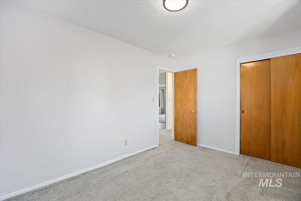 Unfurnished bedroom featuring carpet floors and a closet
