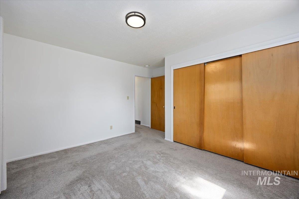 Unfurnished bedroom featuring carpet floors and a closet